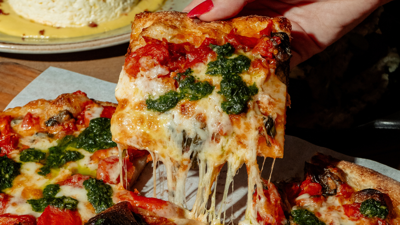 a close up of a plate of food with a slice of pizza