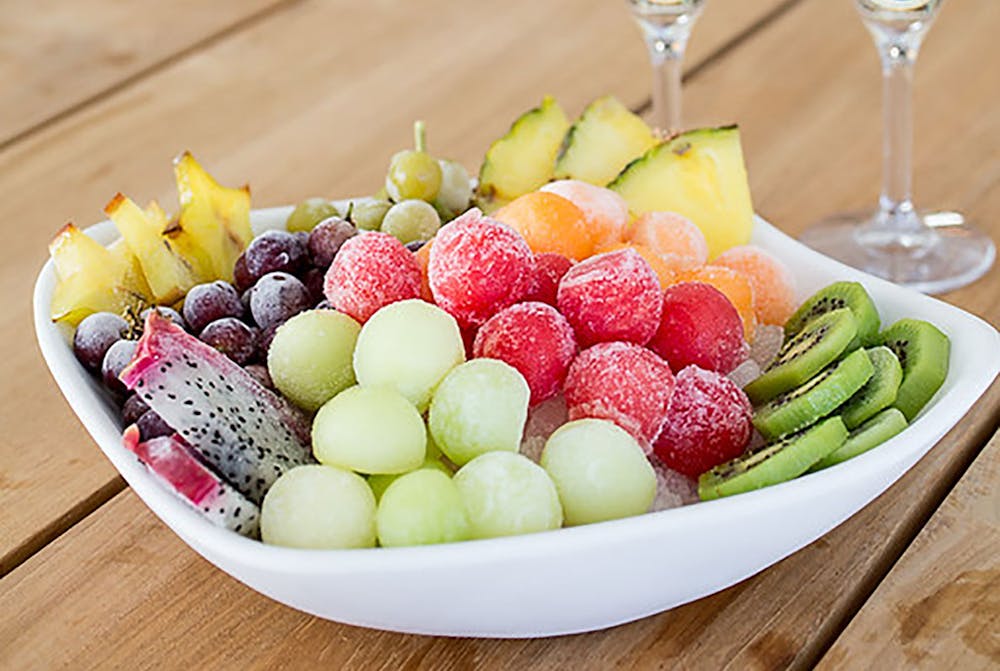 a plate full of food sitting on top of a wooden table