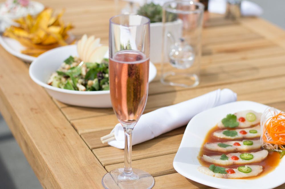 a plate of food sitting on top of a wooden table