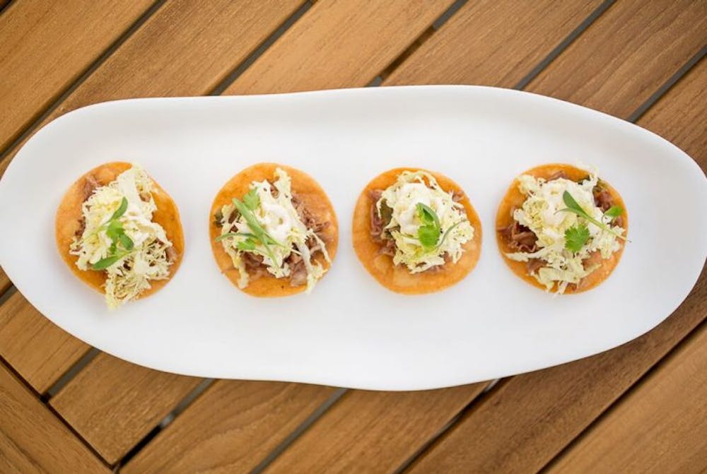 a plate of food sitting on top of a wooden table