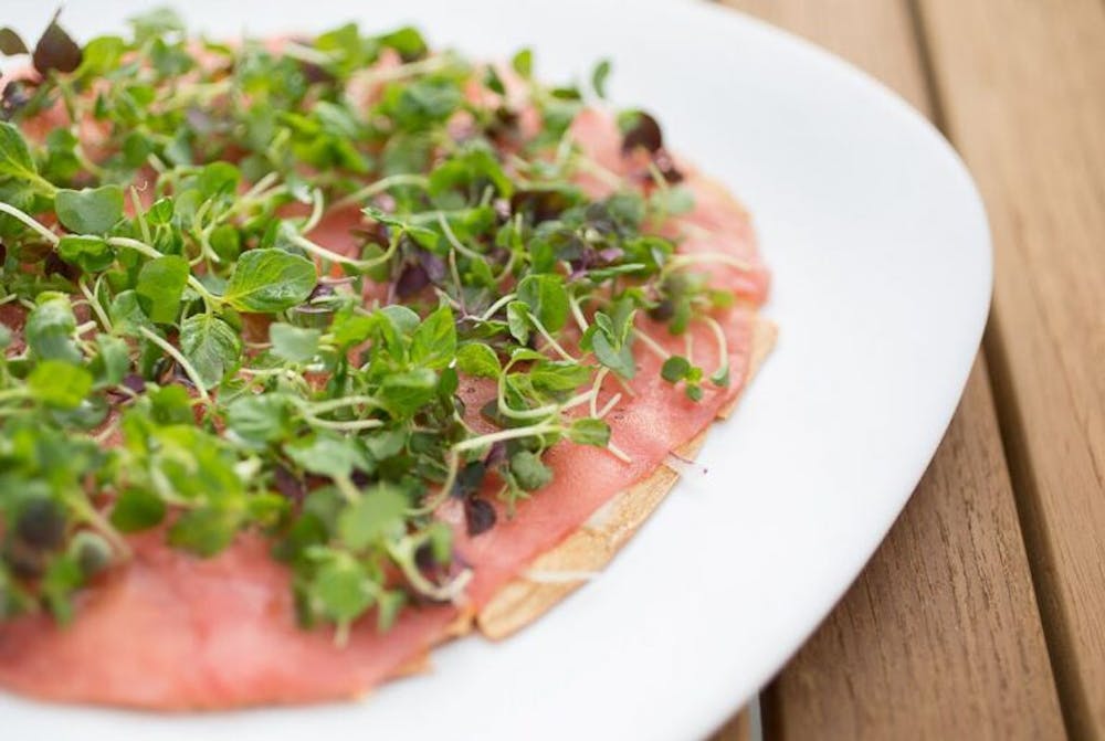 a pizza sitting on top of a plate of food