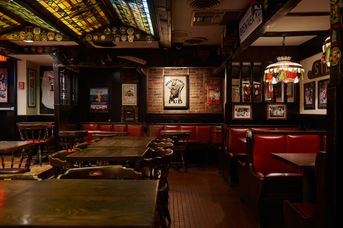 a bar with tables, chairs, and booths