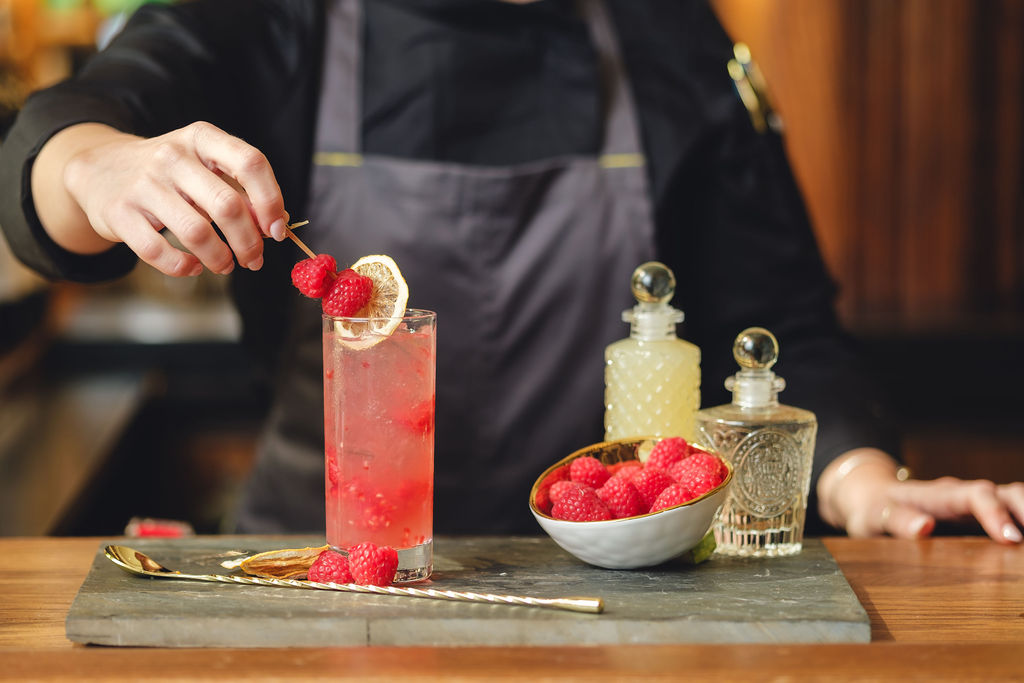 a person cutting a piece of cake on a table