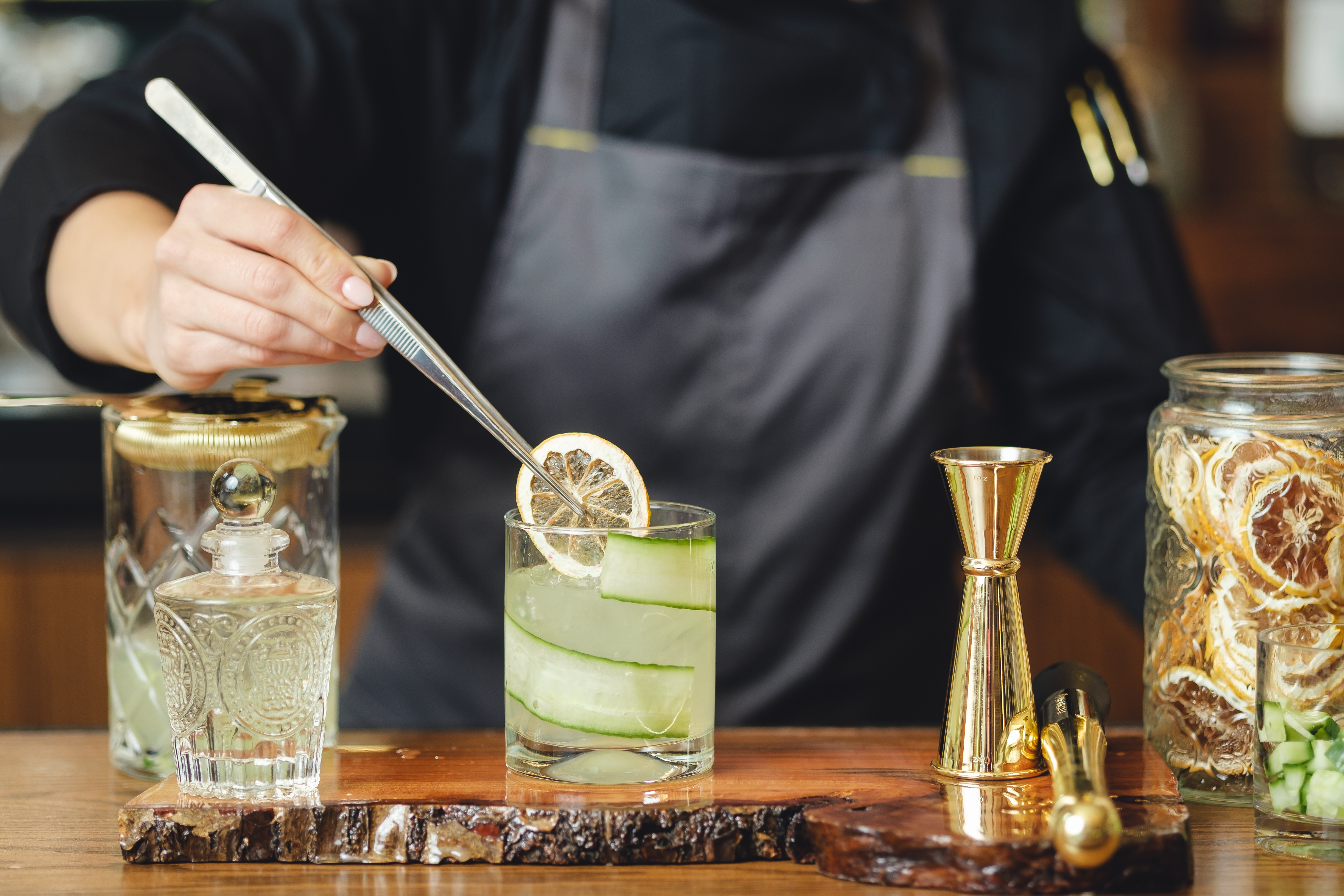 a woman sitting at a table with food and drinks
