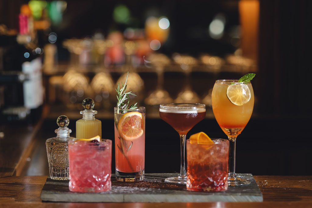 a glass of wine sitting on top of a table