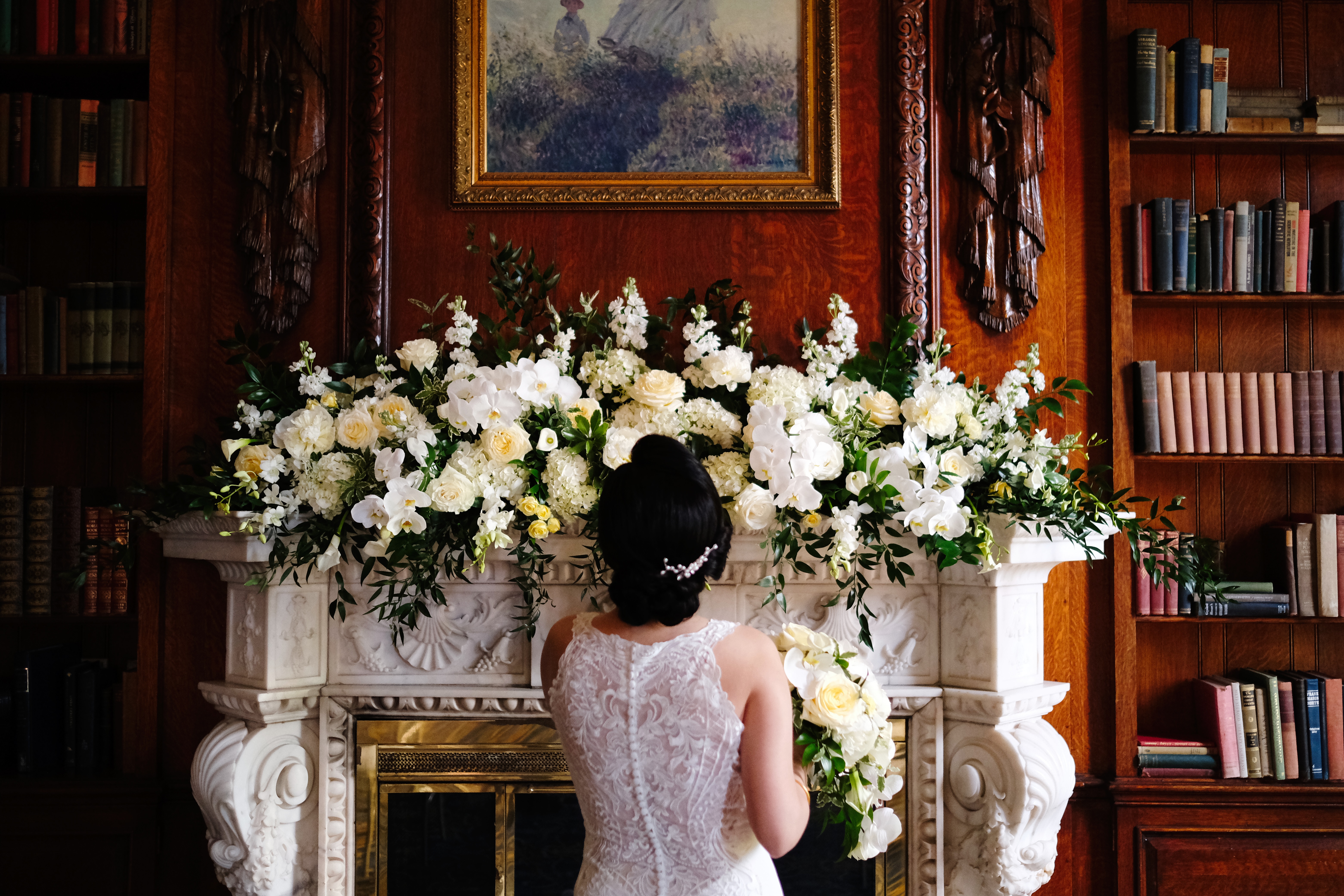 a fire place sitting in a living room with a book shelf