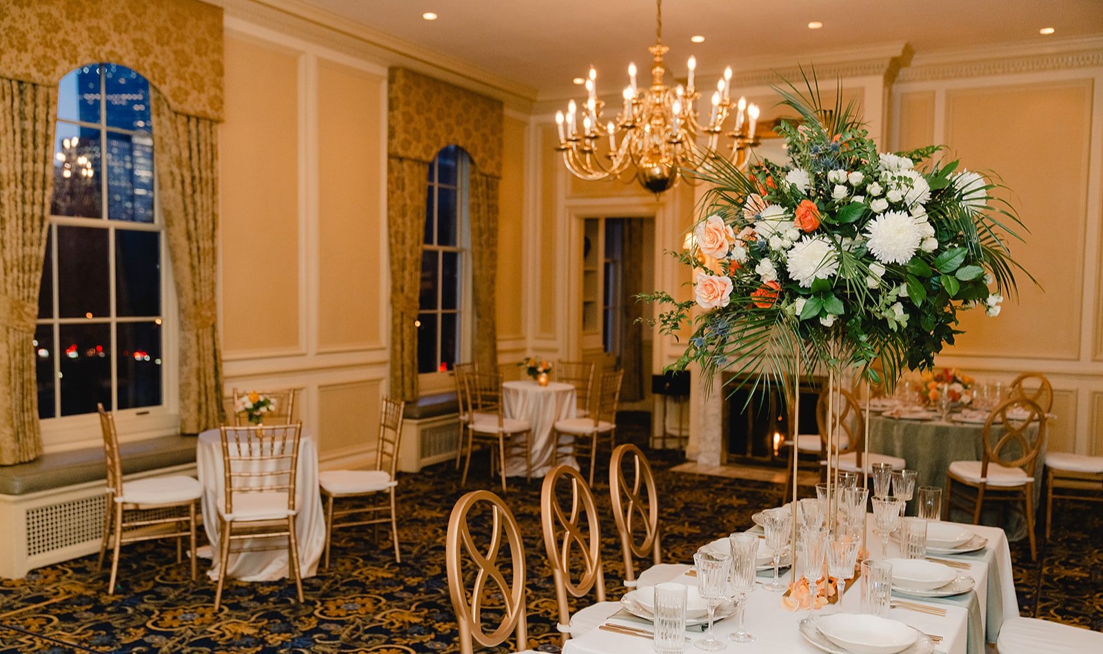 a room filled with furniture and vase of flowers on a table