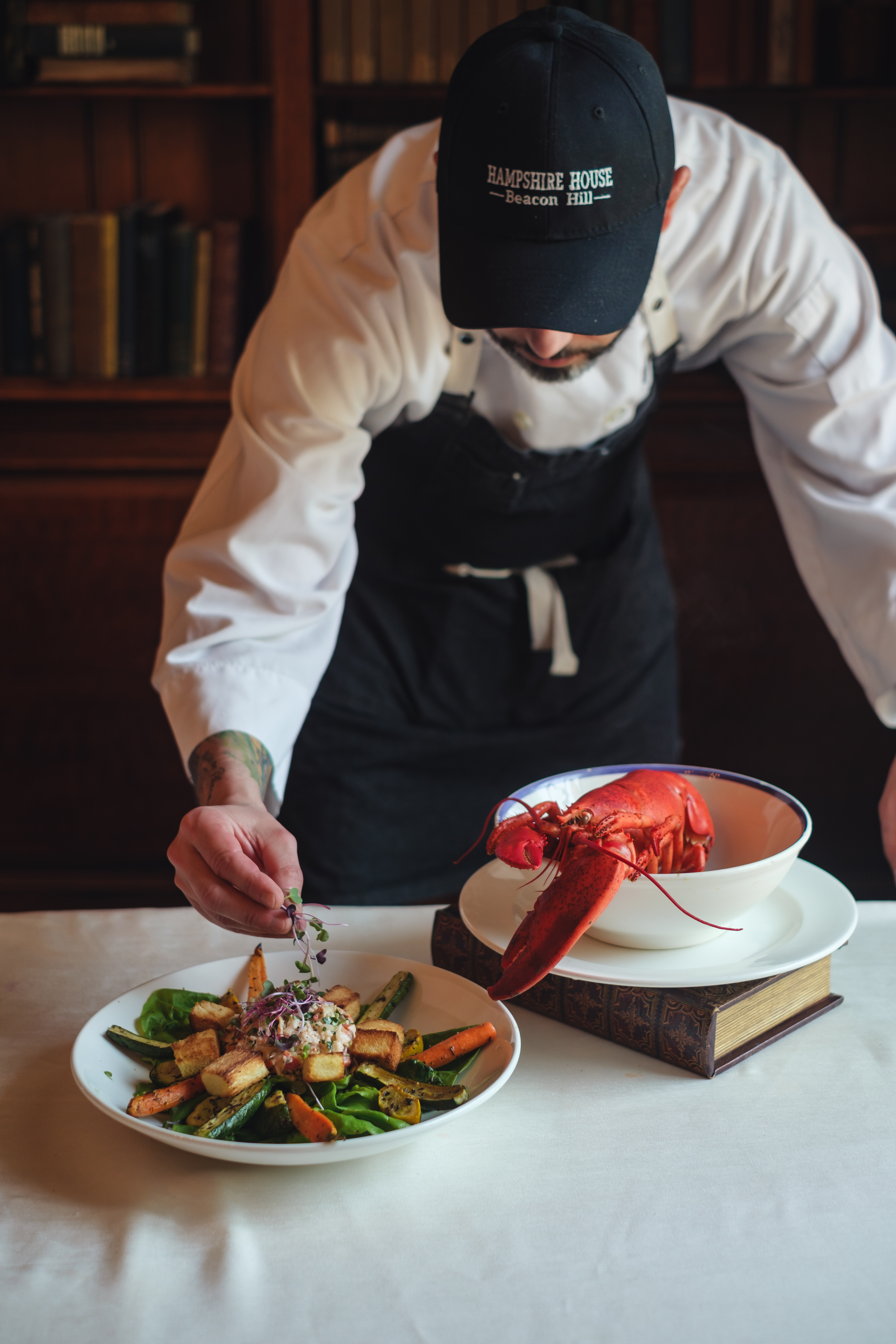 a person sitting at a table with a plate of food
