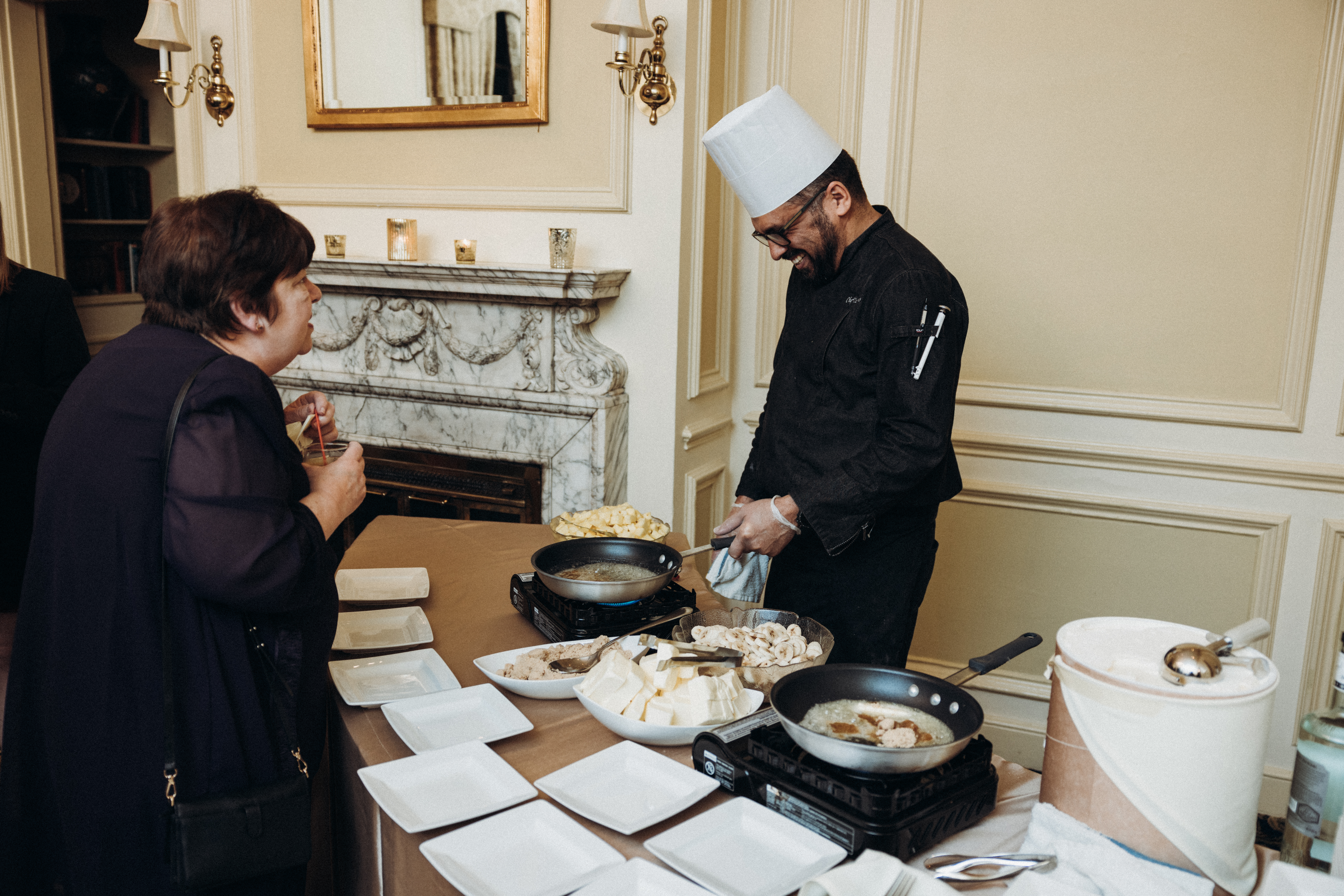a man and woman preparing food in a kitchen