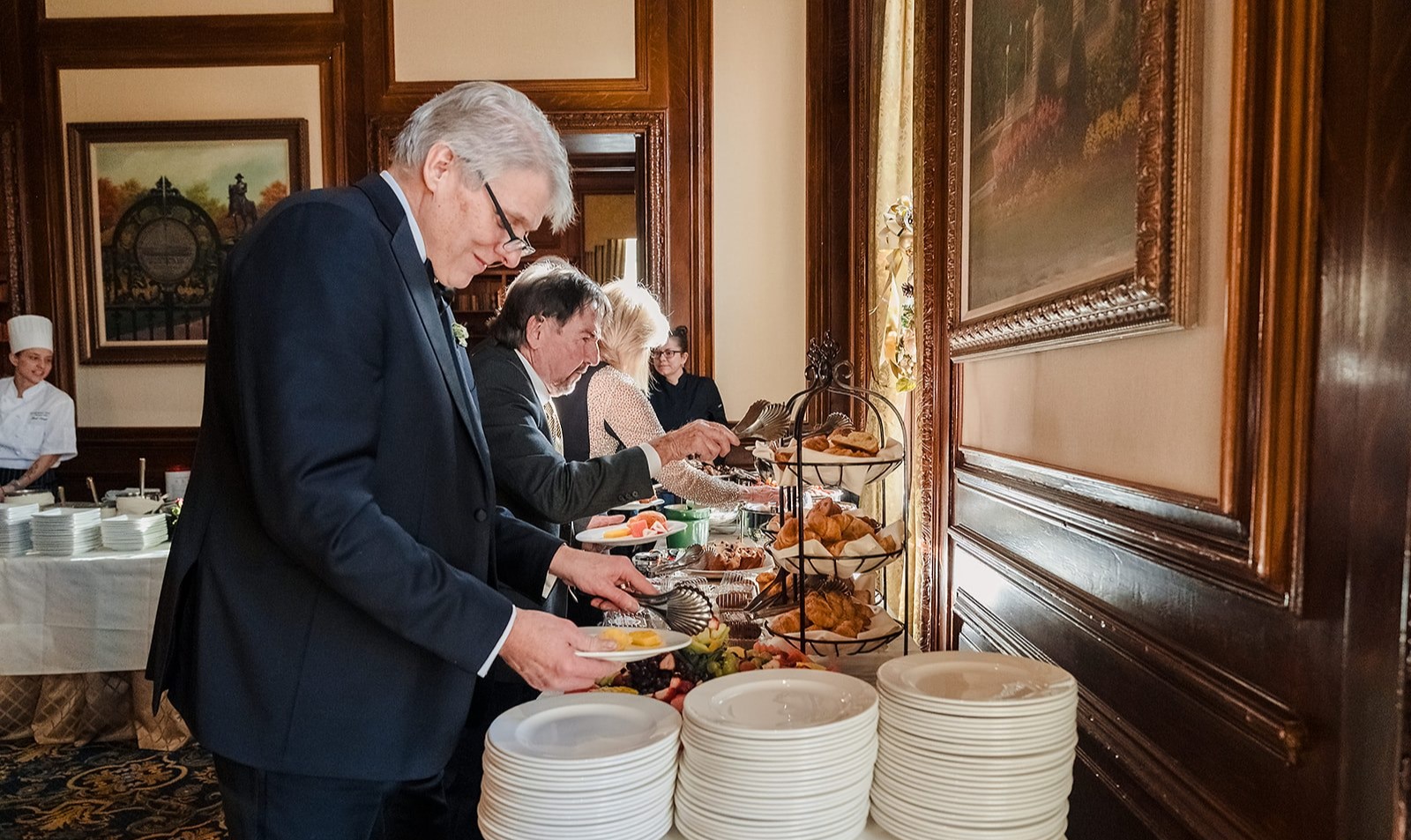 a man and woman preparing food in a kitchen