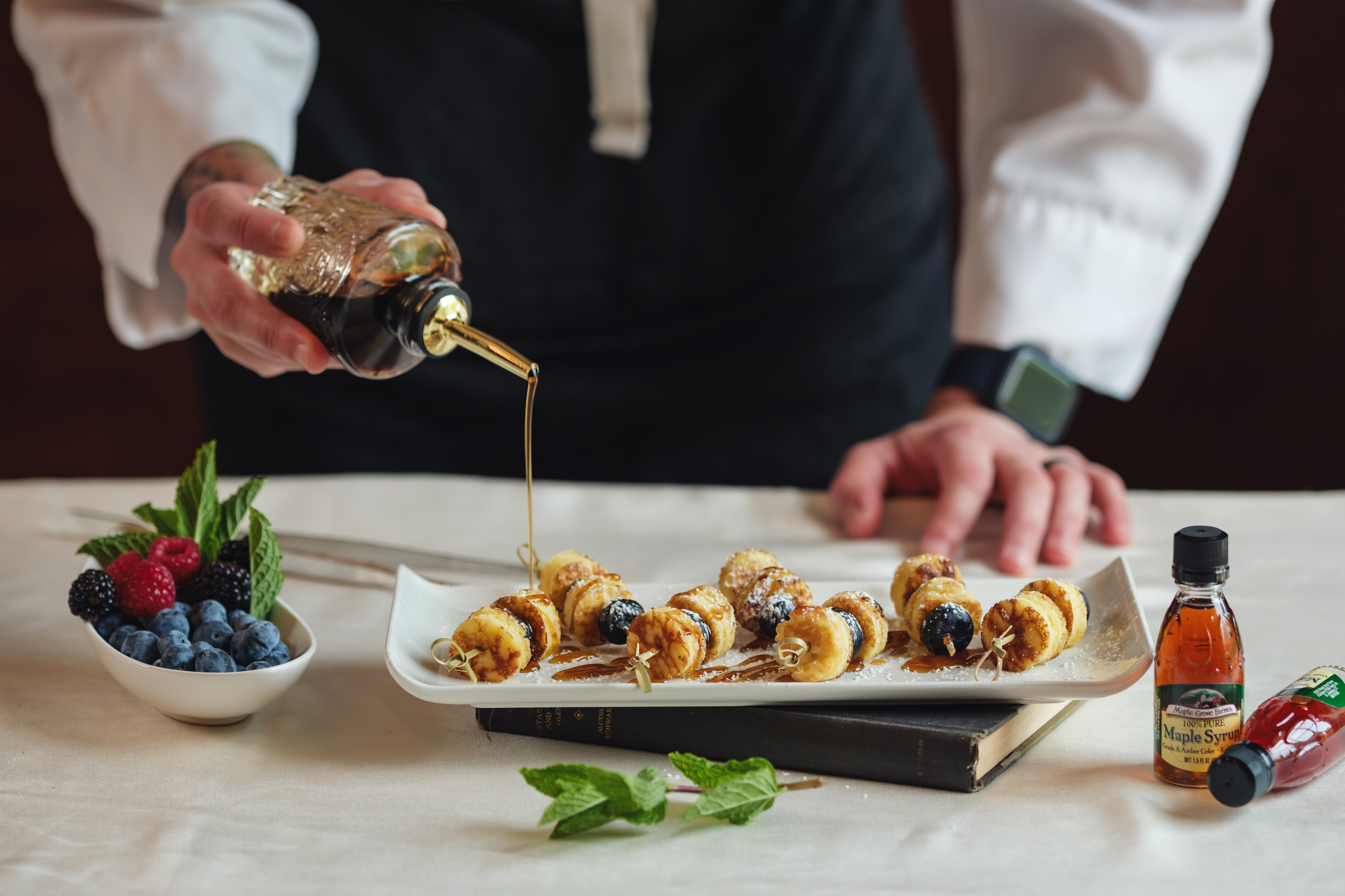 a woman sitting at a table with a plate of food