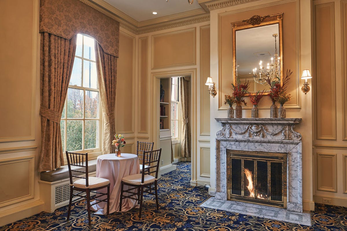 a room with a table and a fireplace