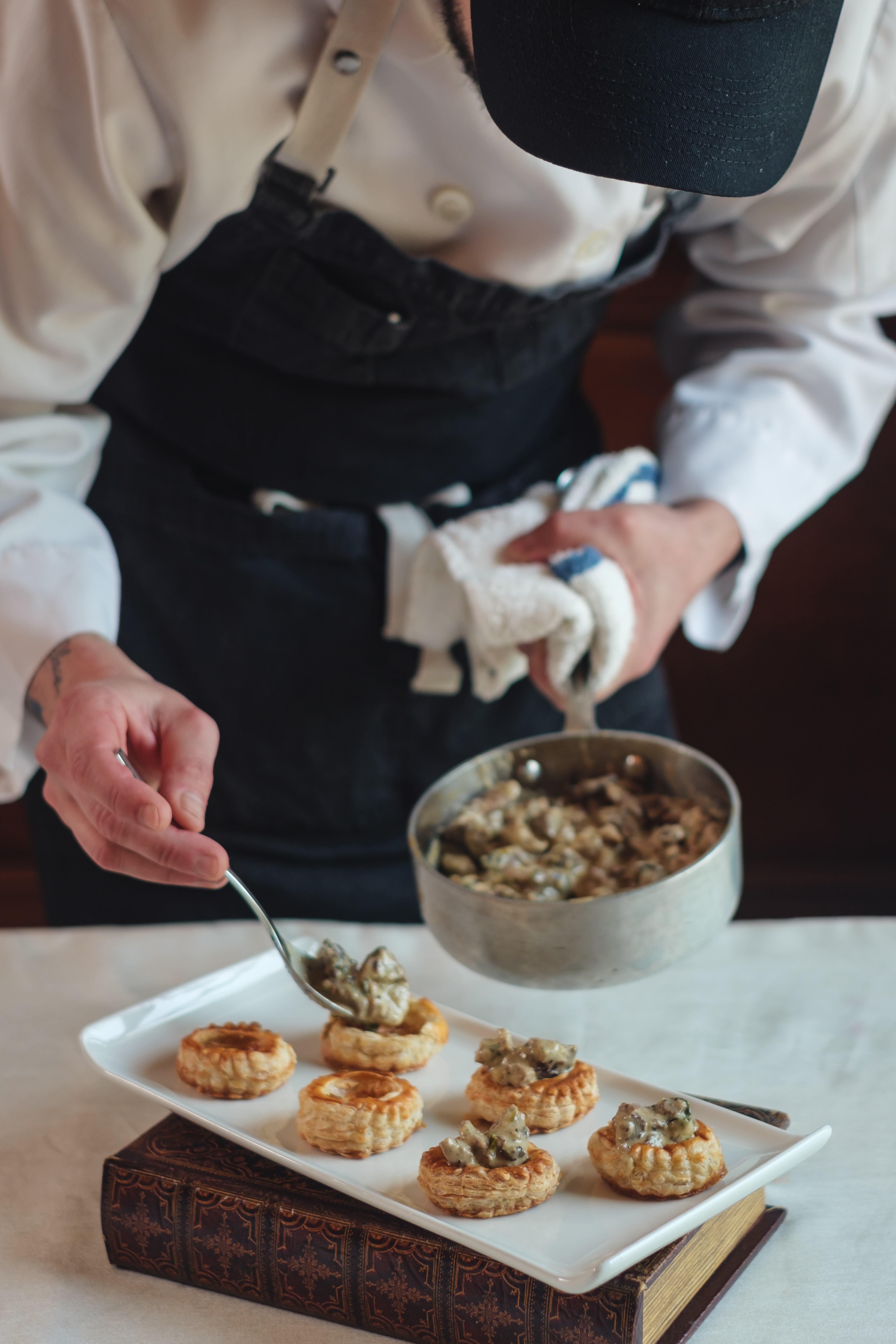 a person sitting at a table with a plate of food