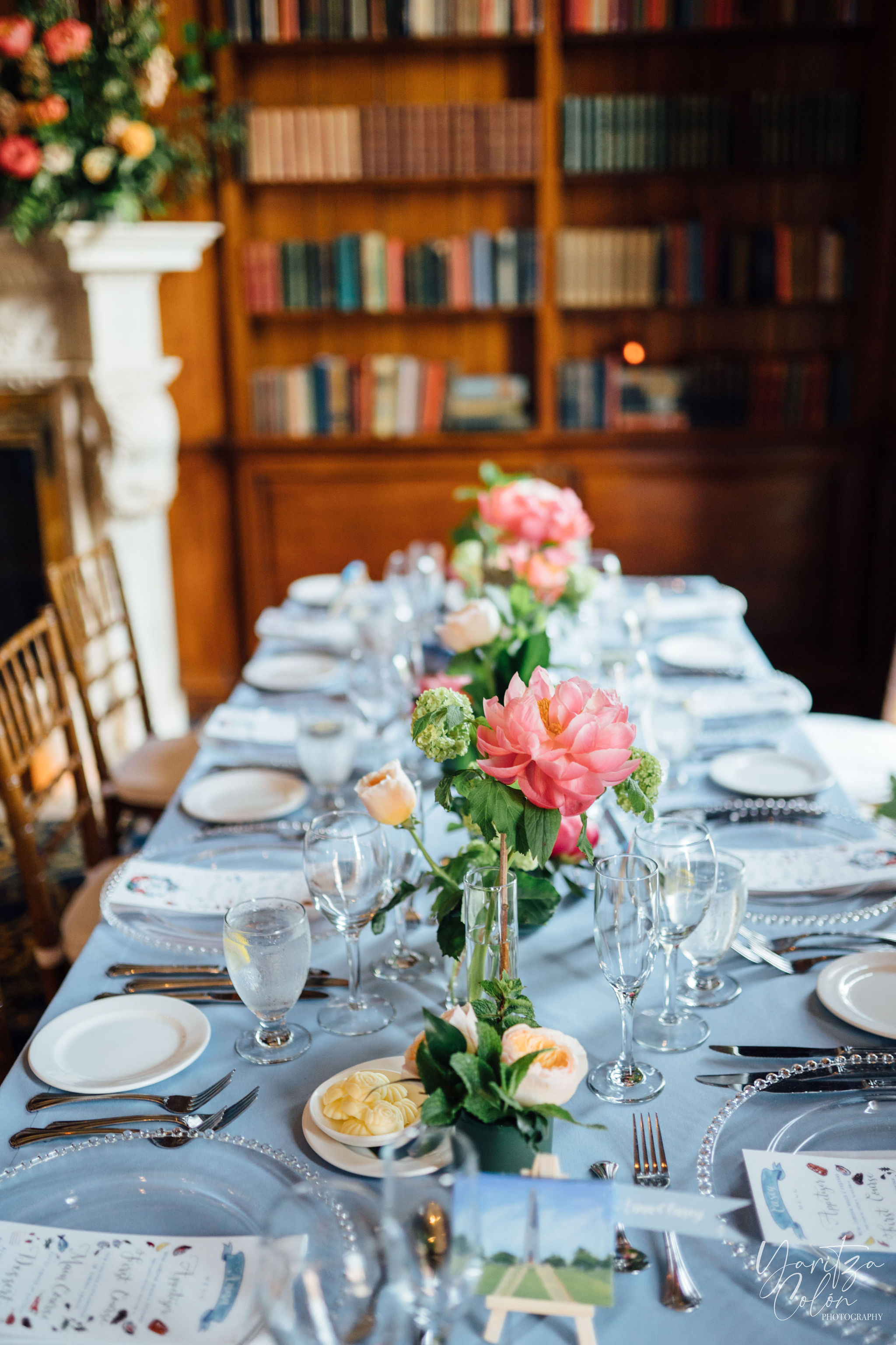 a group of people sitting at a table with a cake on a plate