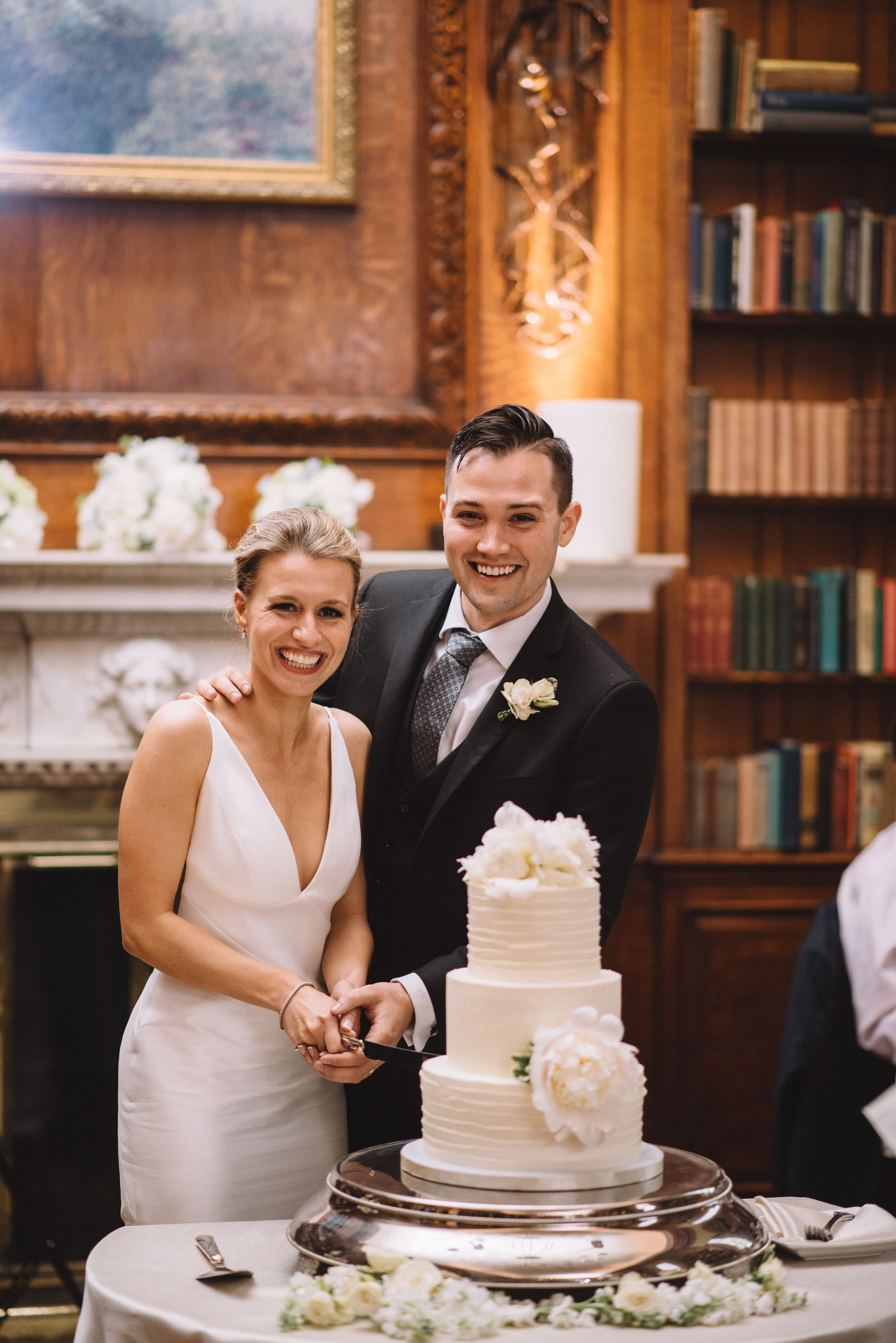 a bride and groom cutting cake