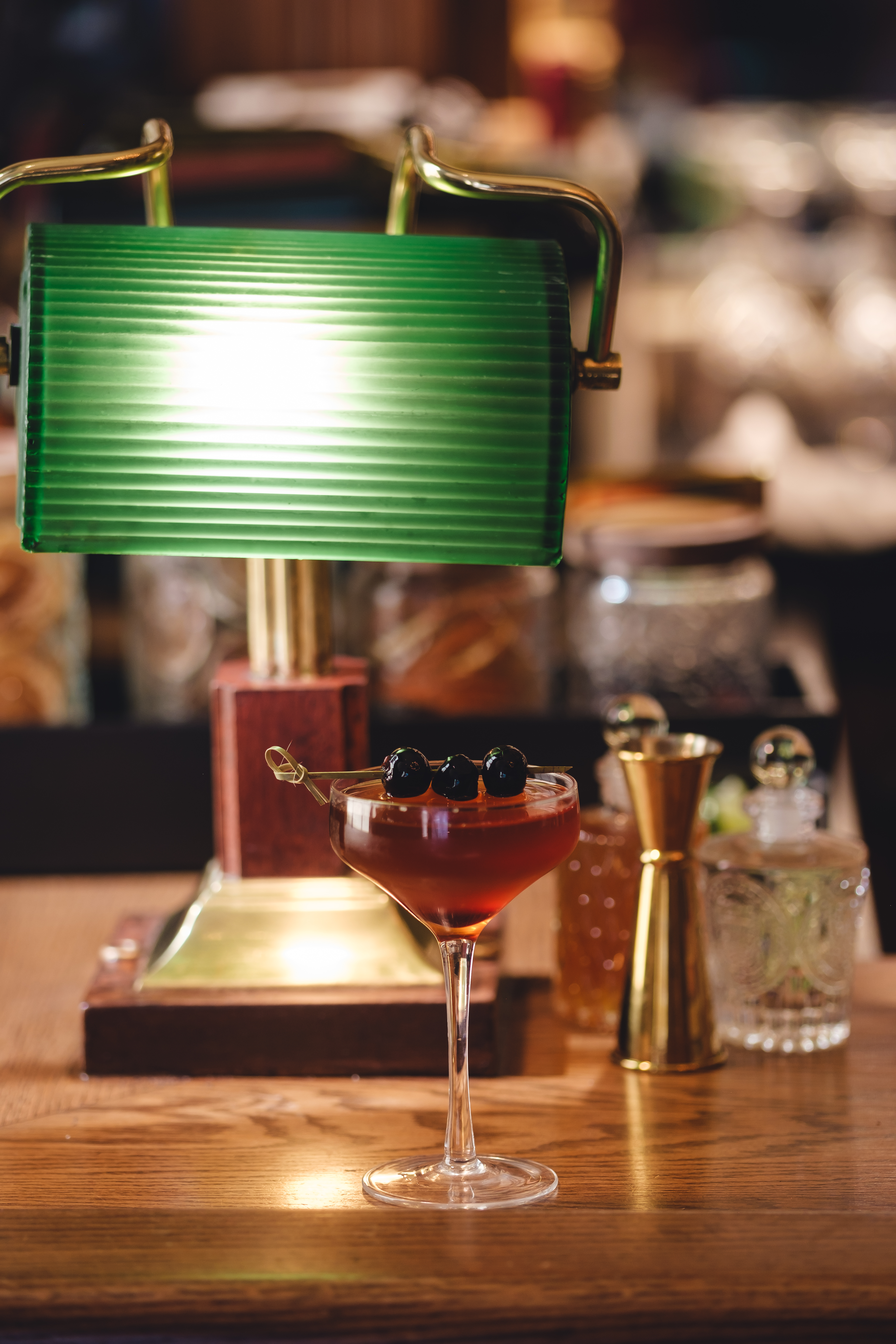 a glass of wine sitting on top of a wooden table