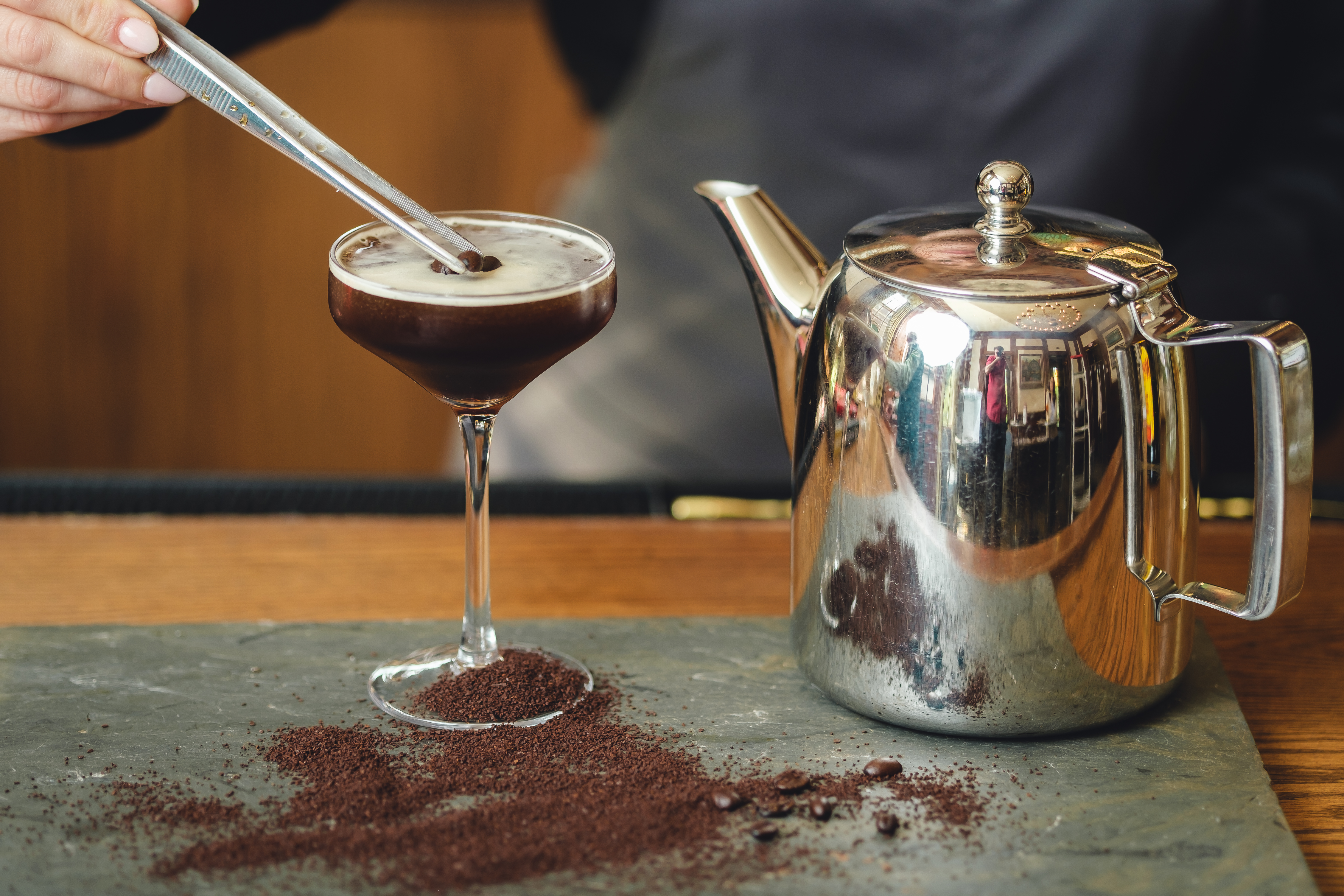 a glass of wine sitting on top of a wooden table