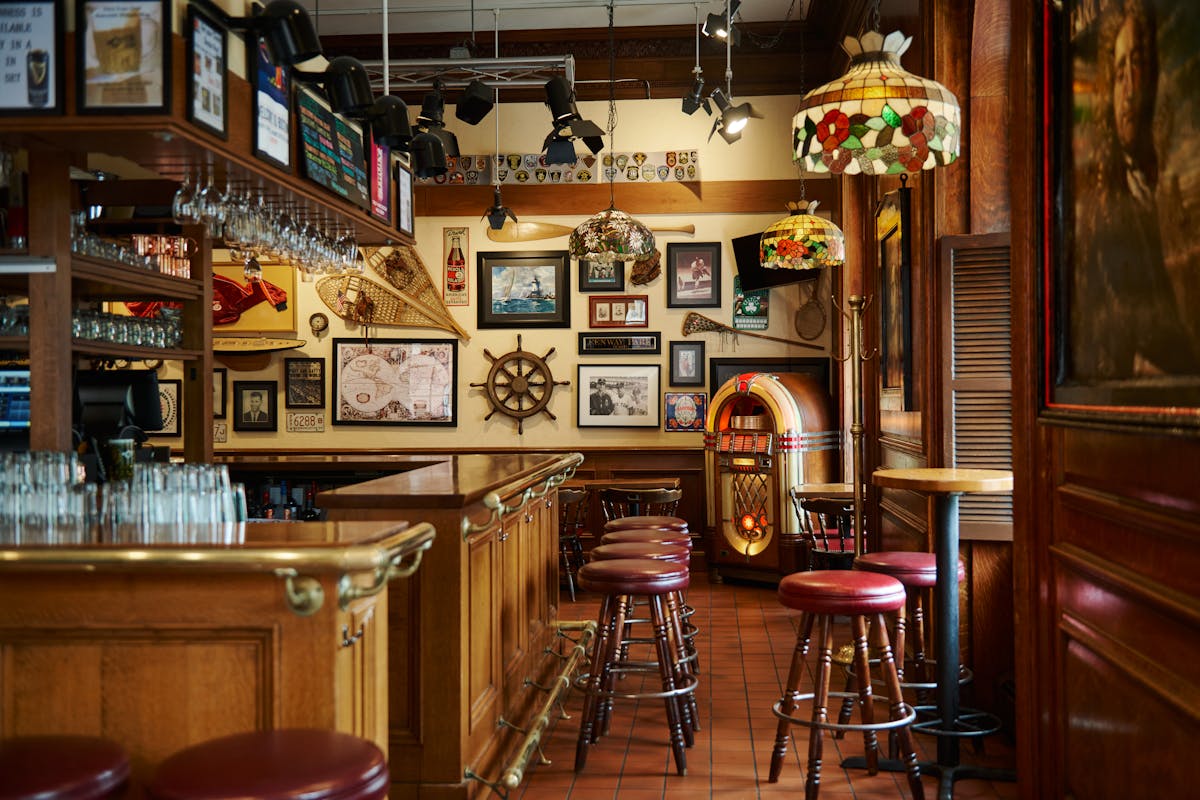 a bar with barstools and a jukebox