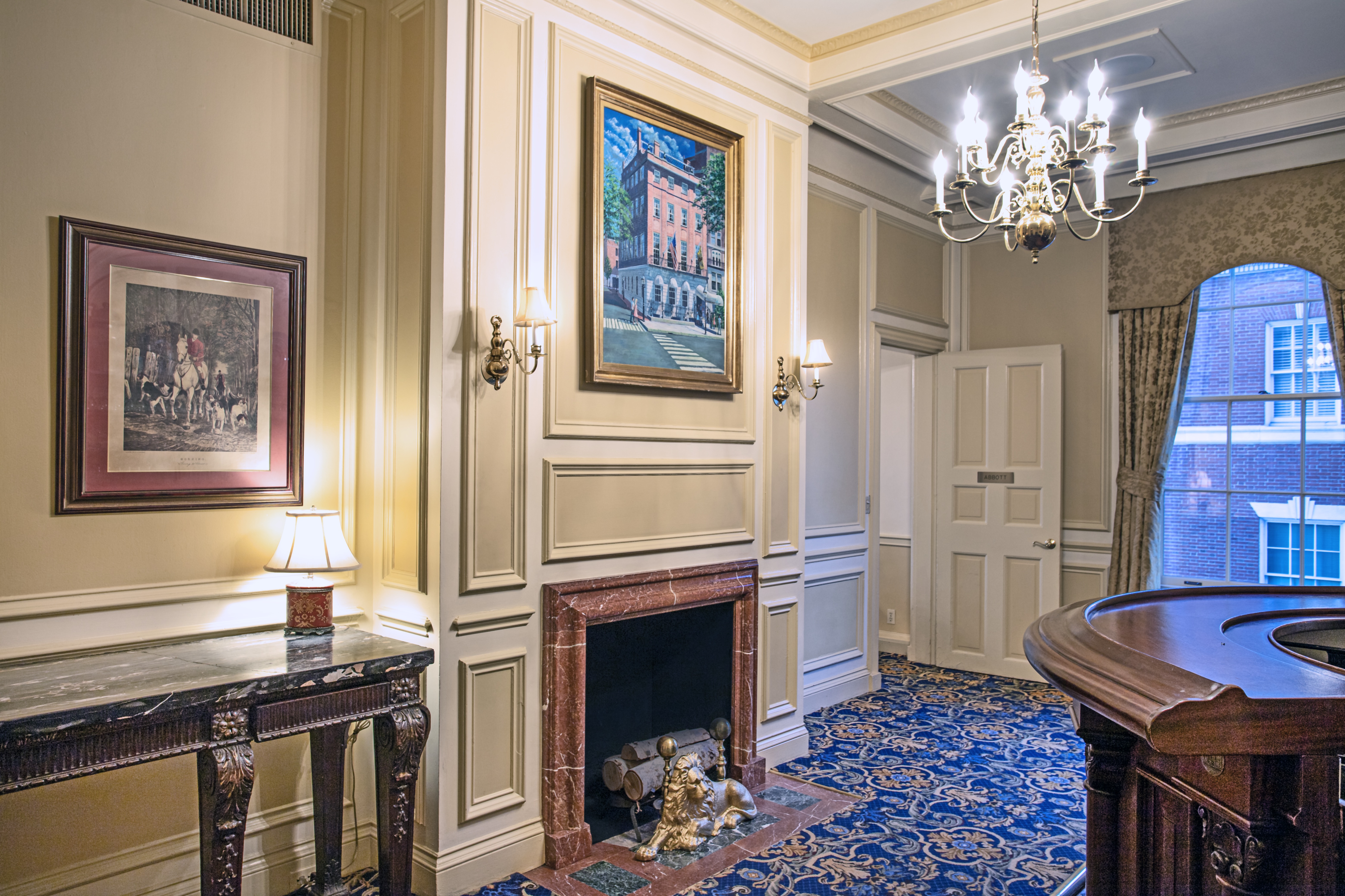 a room with a fireplace and a large window