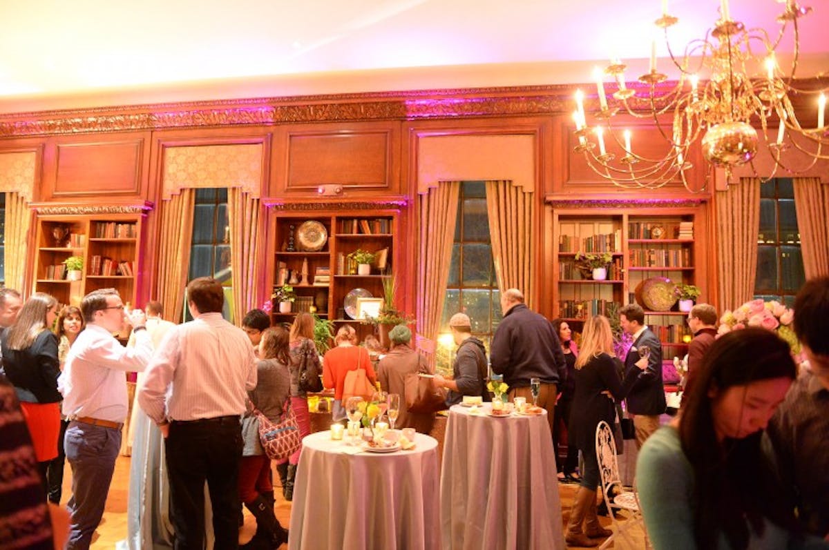 a group of people standing around a table