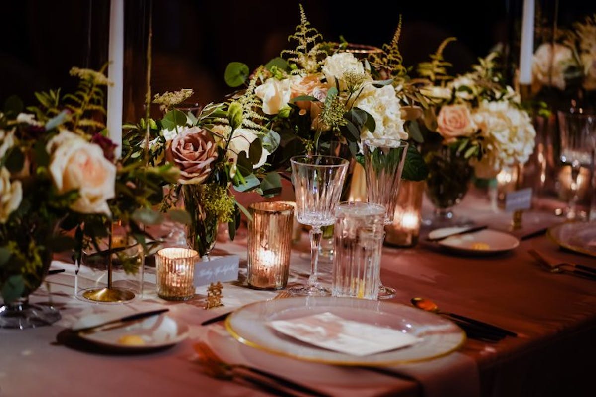 a group of people sitting at a table with wine glasses