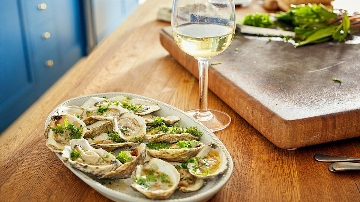 a plate of food and glass of wine