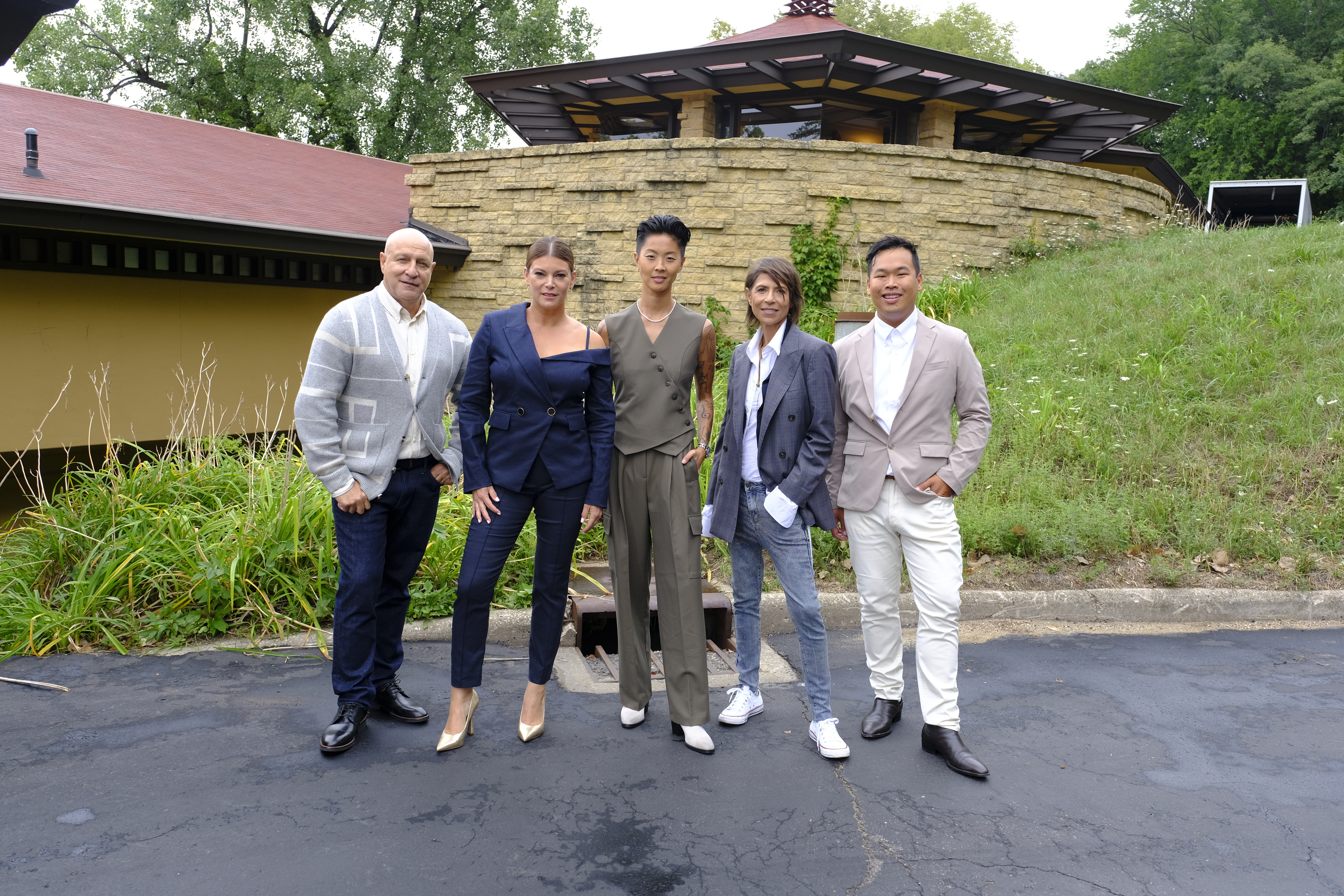 Tom Colicchio, Gail Simmons, Kristen Kish standing in front of a building