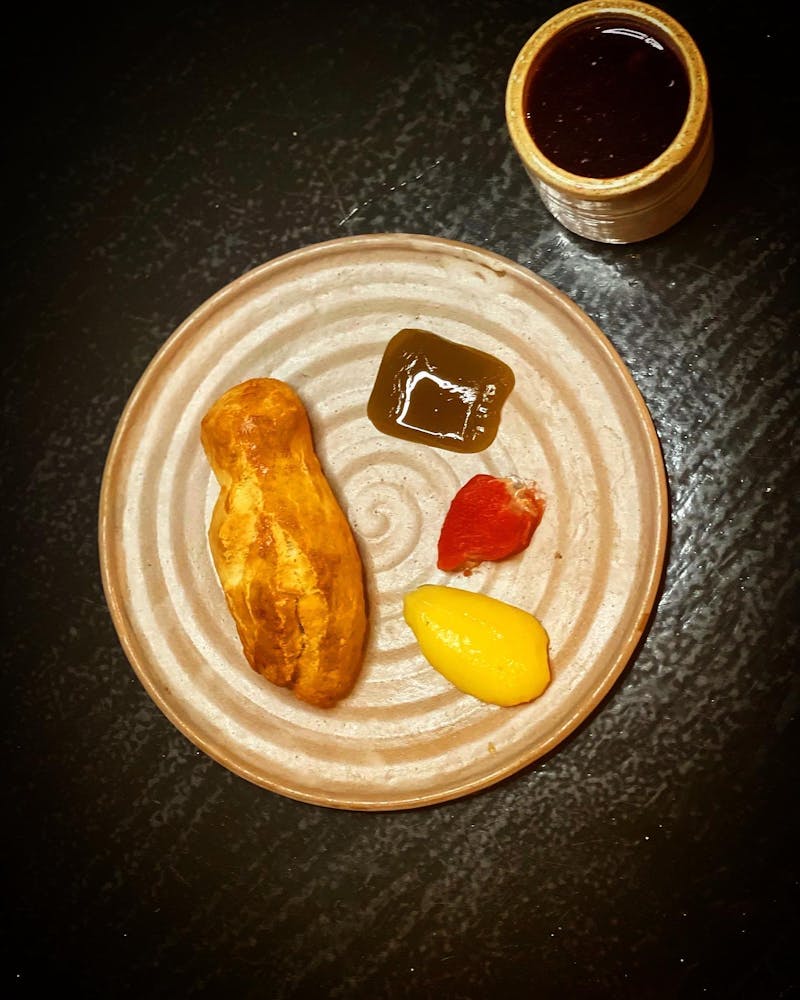 a plate of food with a slice of orange