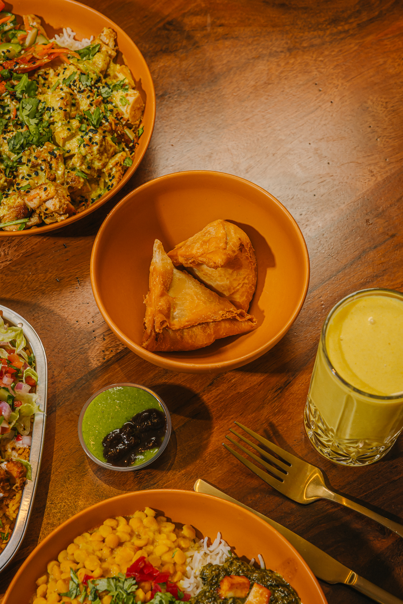 a bowl of food sitting on top of a wooden table