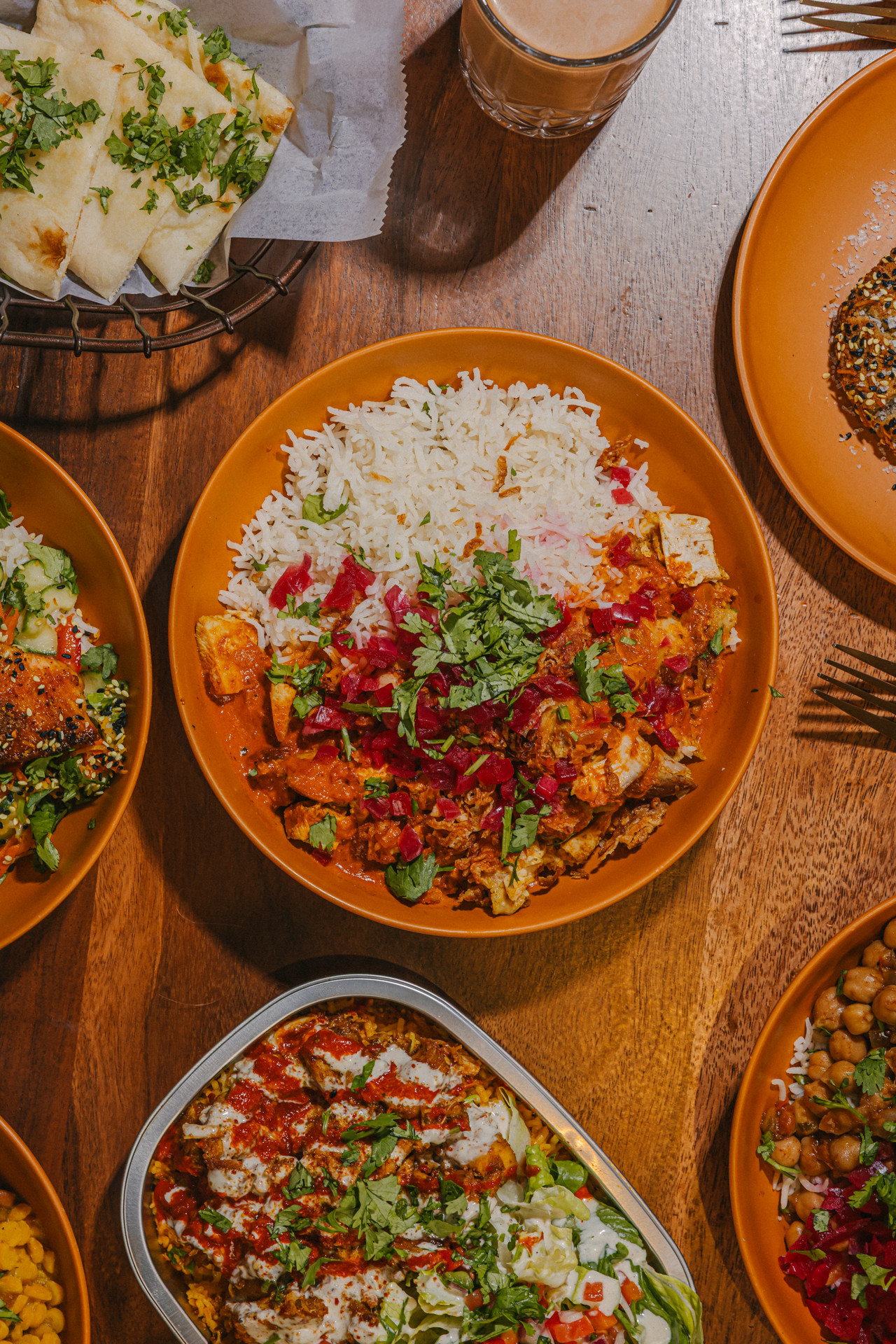 a bowl of food sitting on top of a wooden table