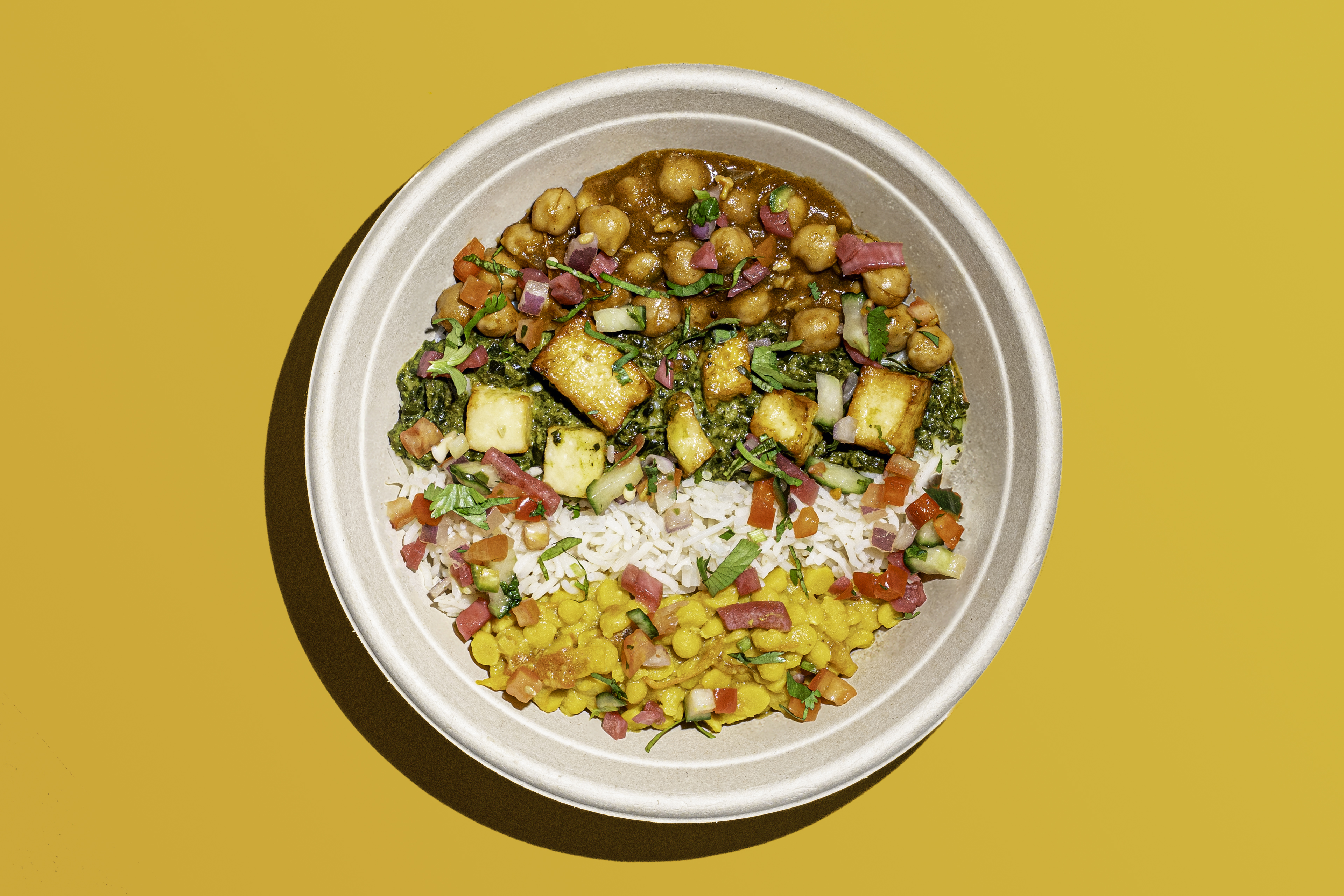 a bowl of food on a yellow background