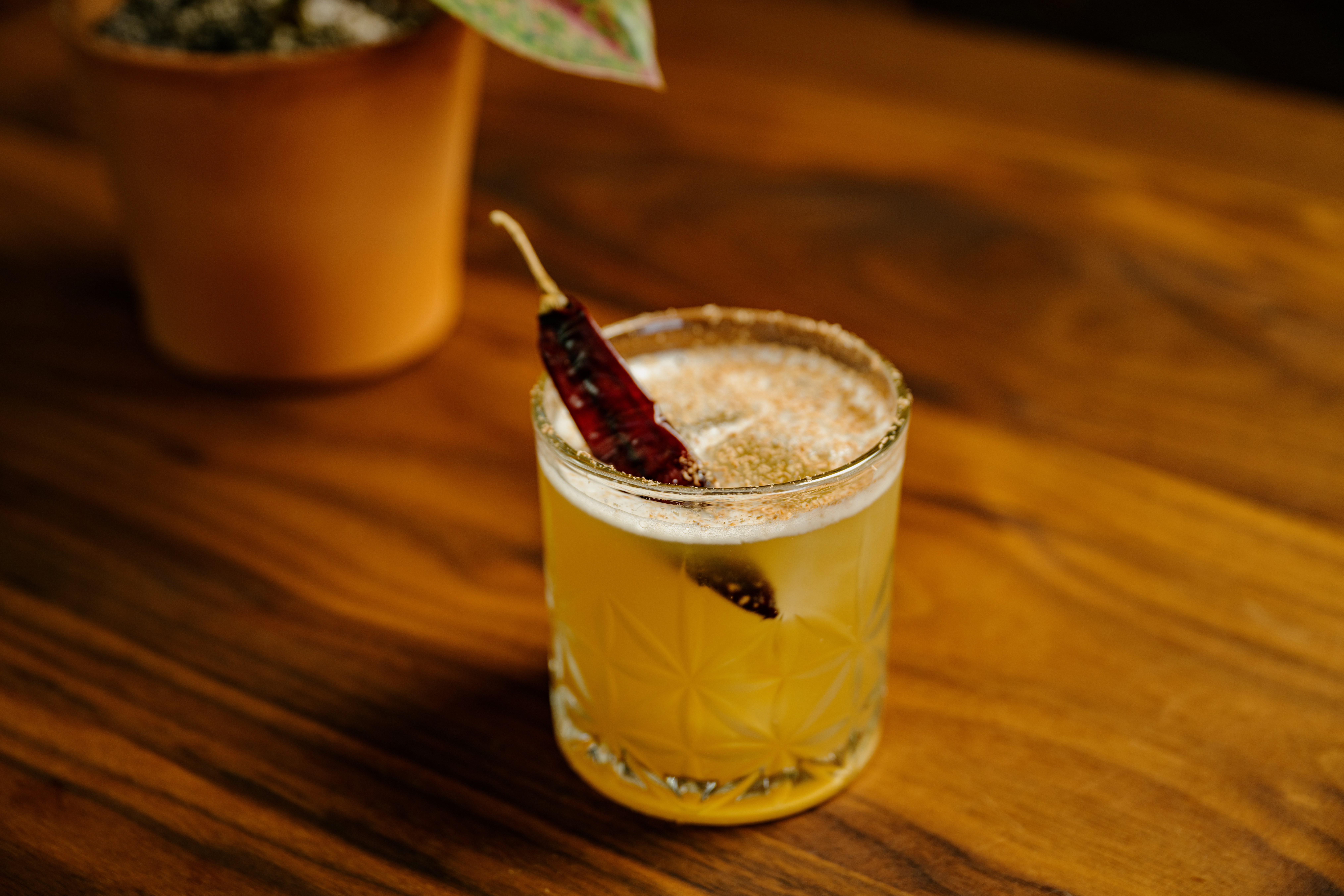 a cup of coffee sitting on top of a wooden table