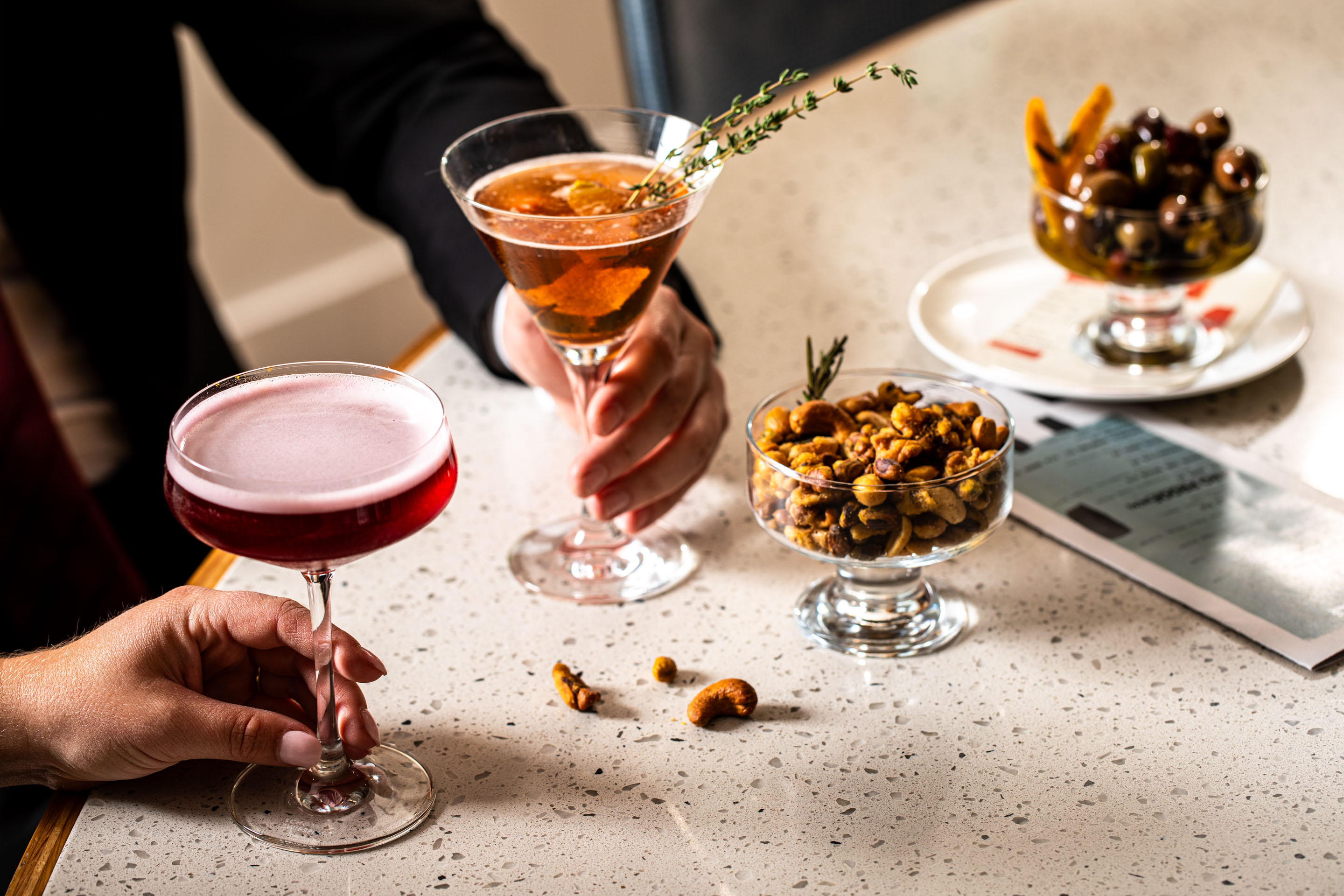 a person sitting at a table with wine glasses