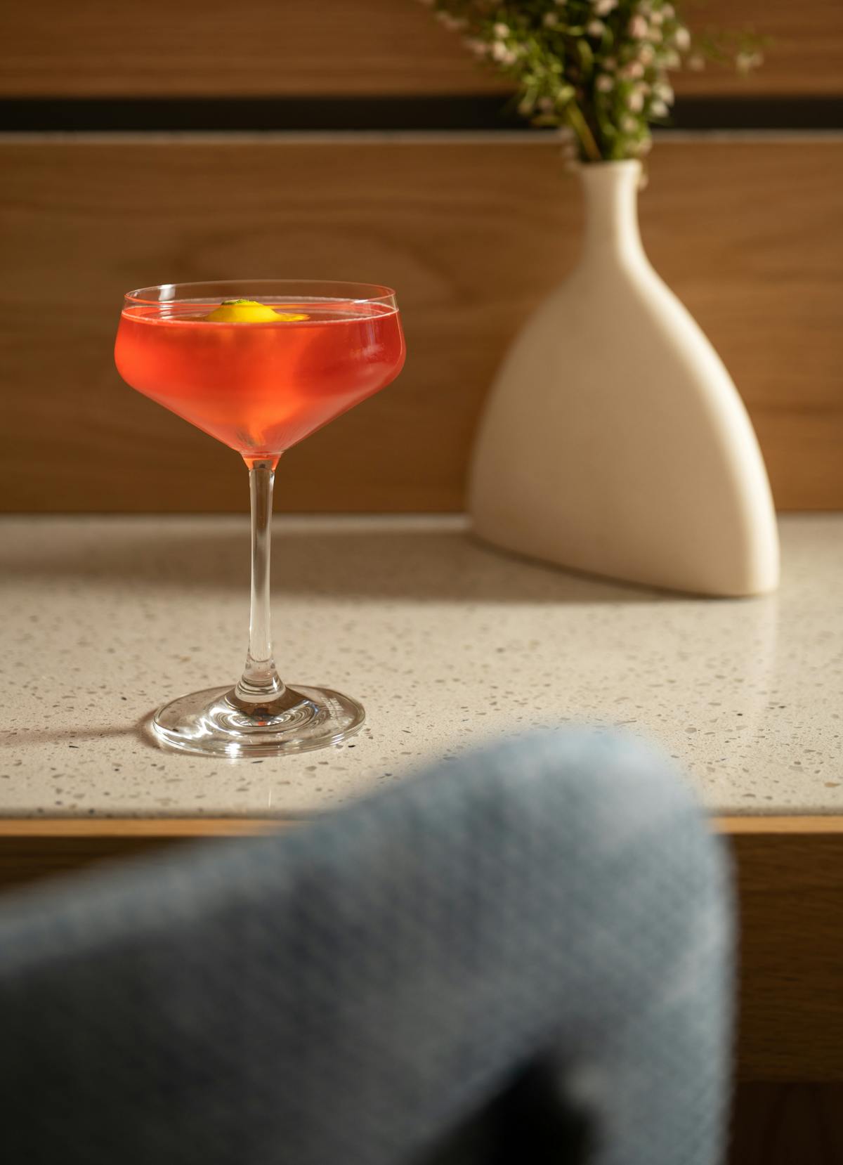 a glass of wine sitting on top of a wooden table