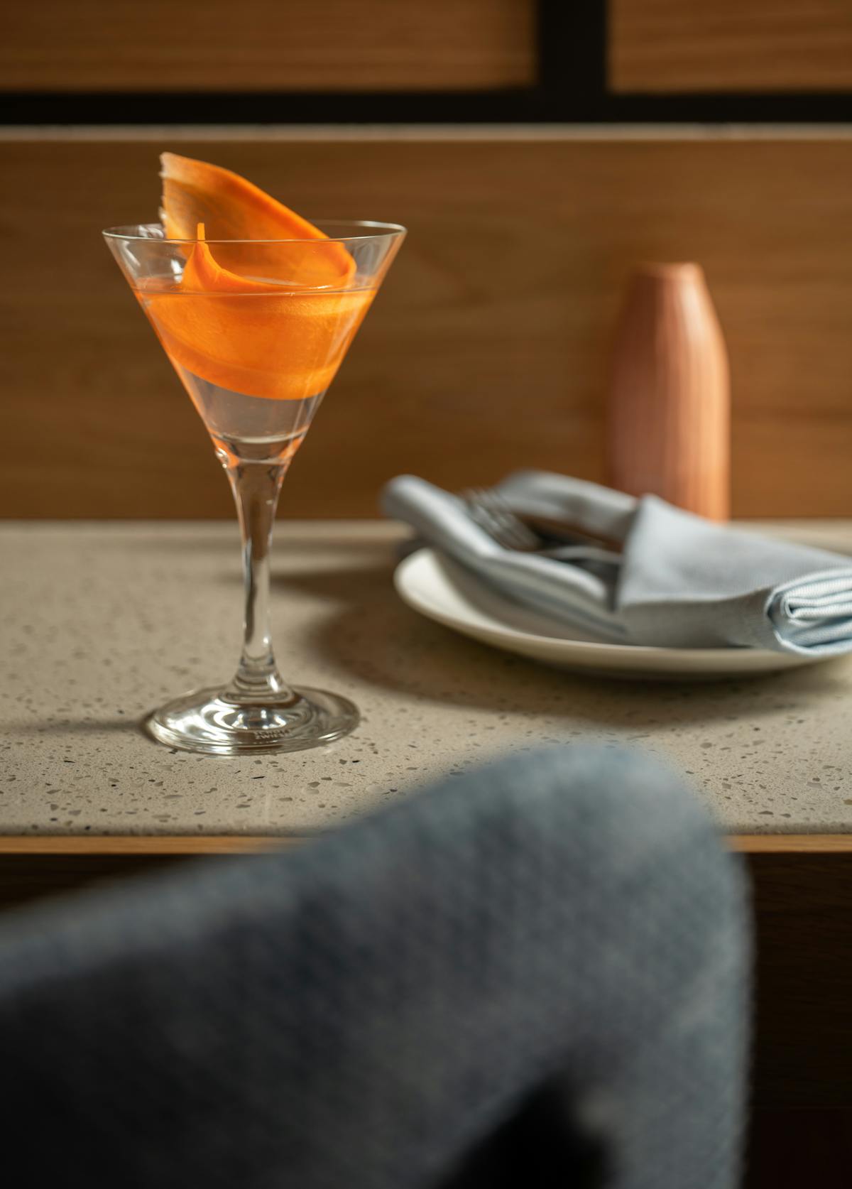 a glass of wine sitting on top of a wooden table