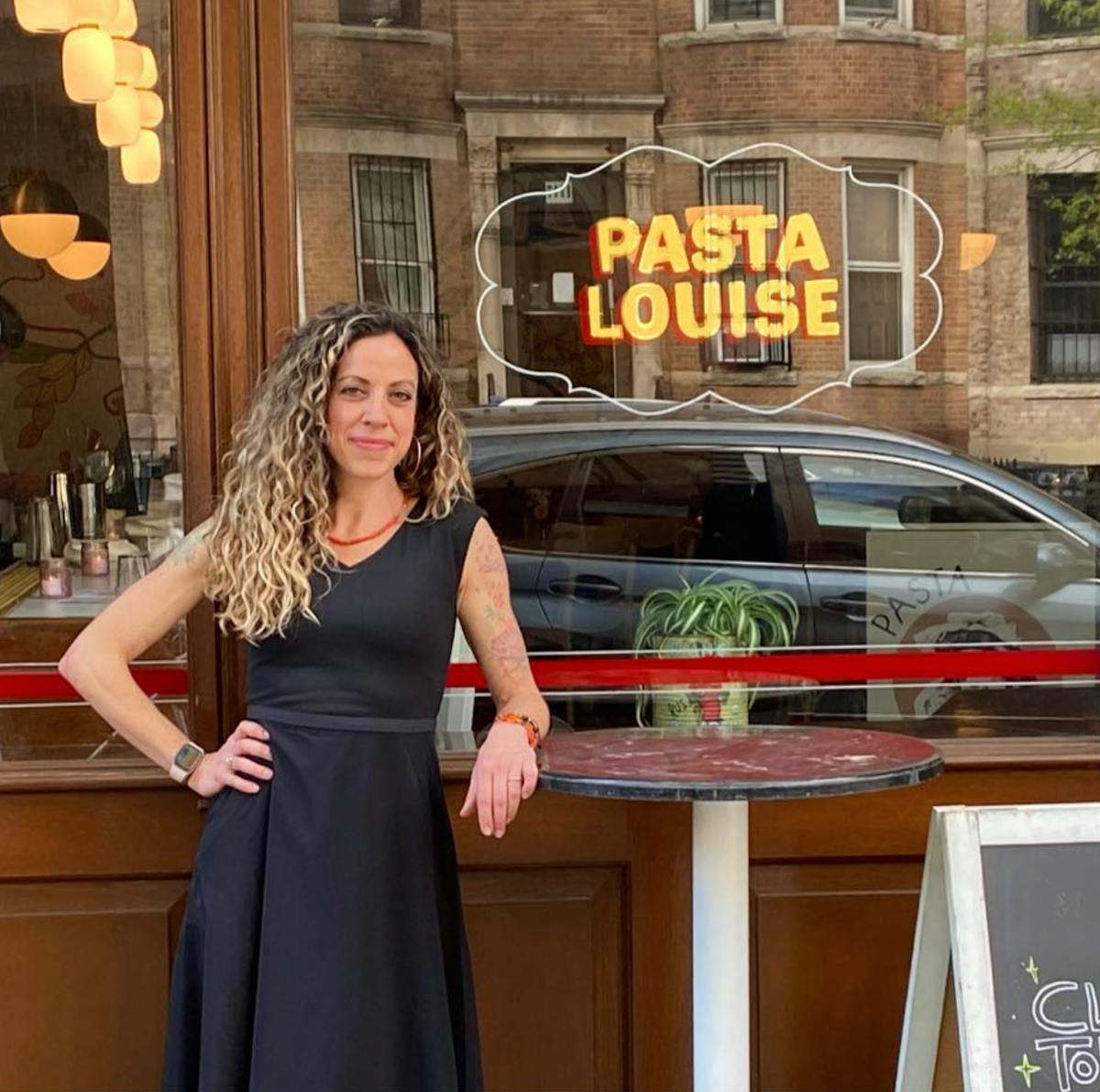 a woman standing in front of a store