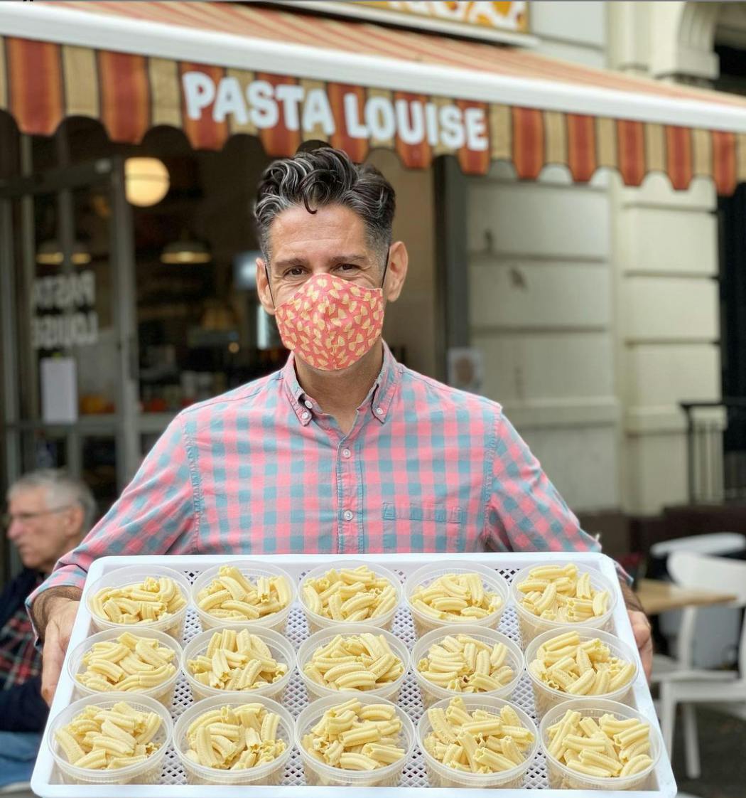 a man standing in front of a cake