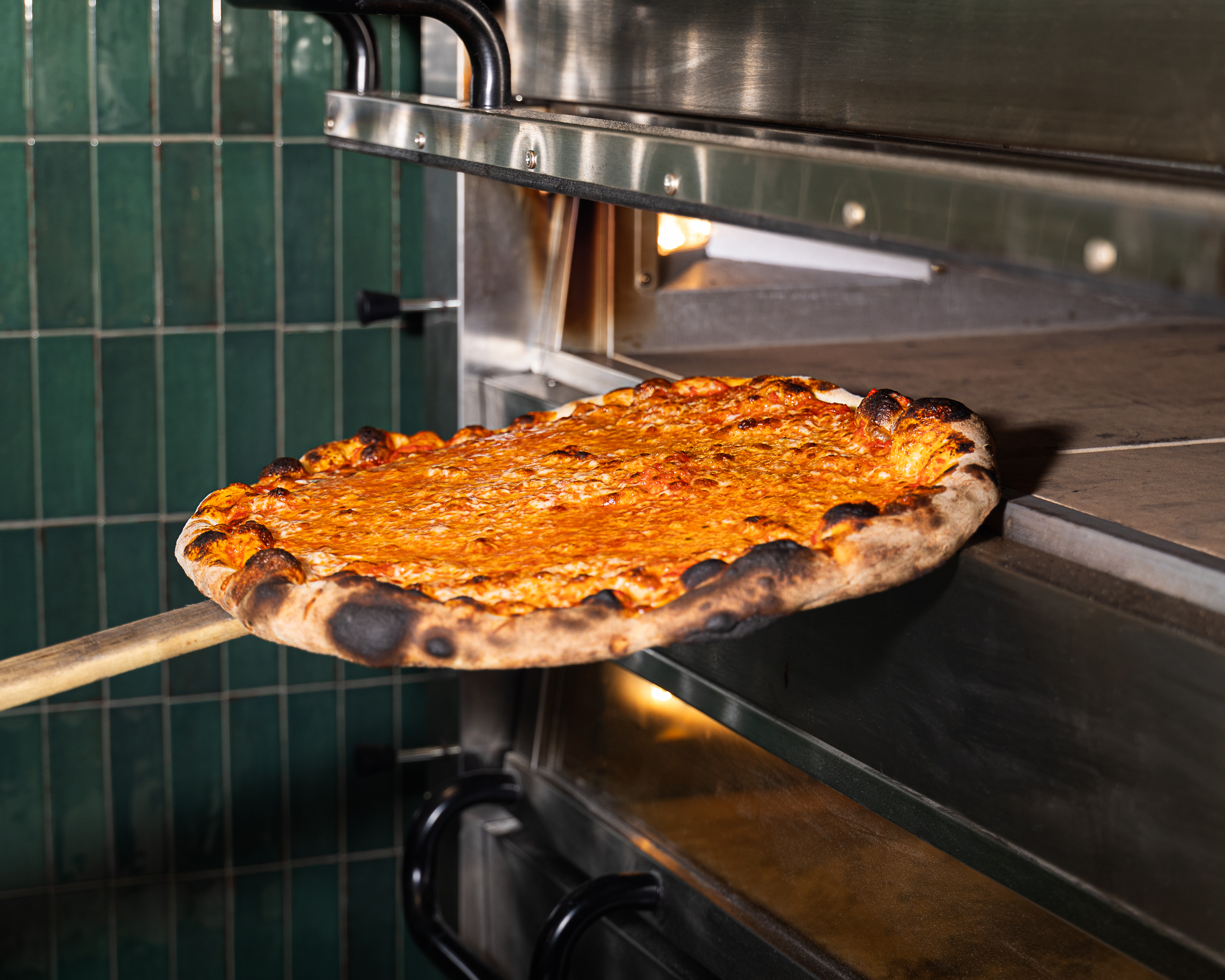 a pizza sitting on top of a metal pan on a table