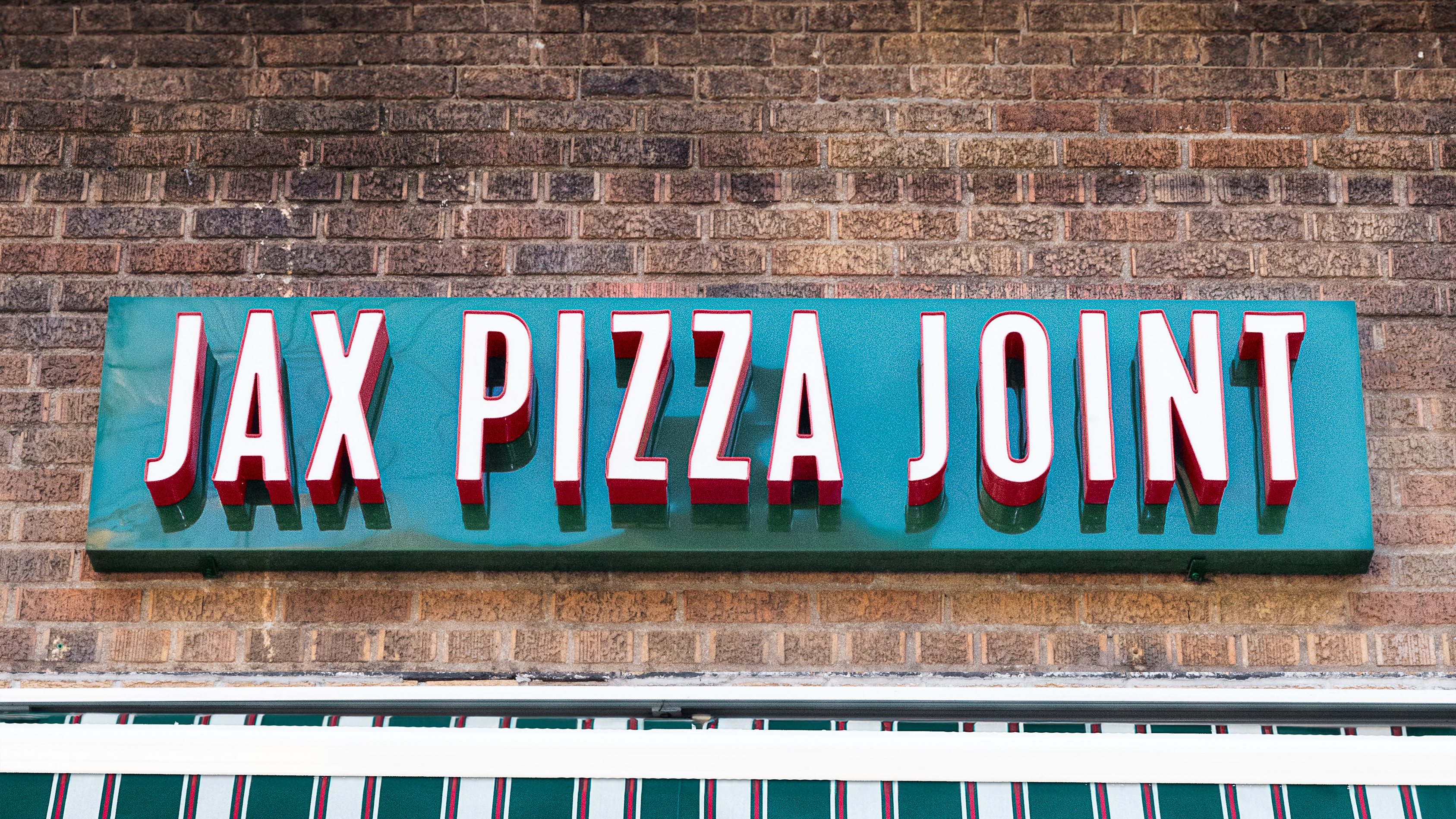 a sign on a brick wall