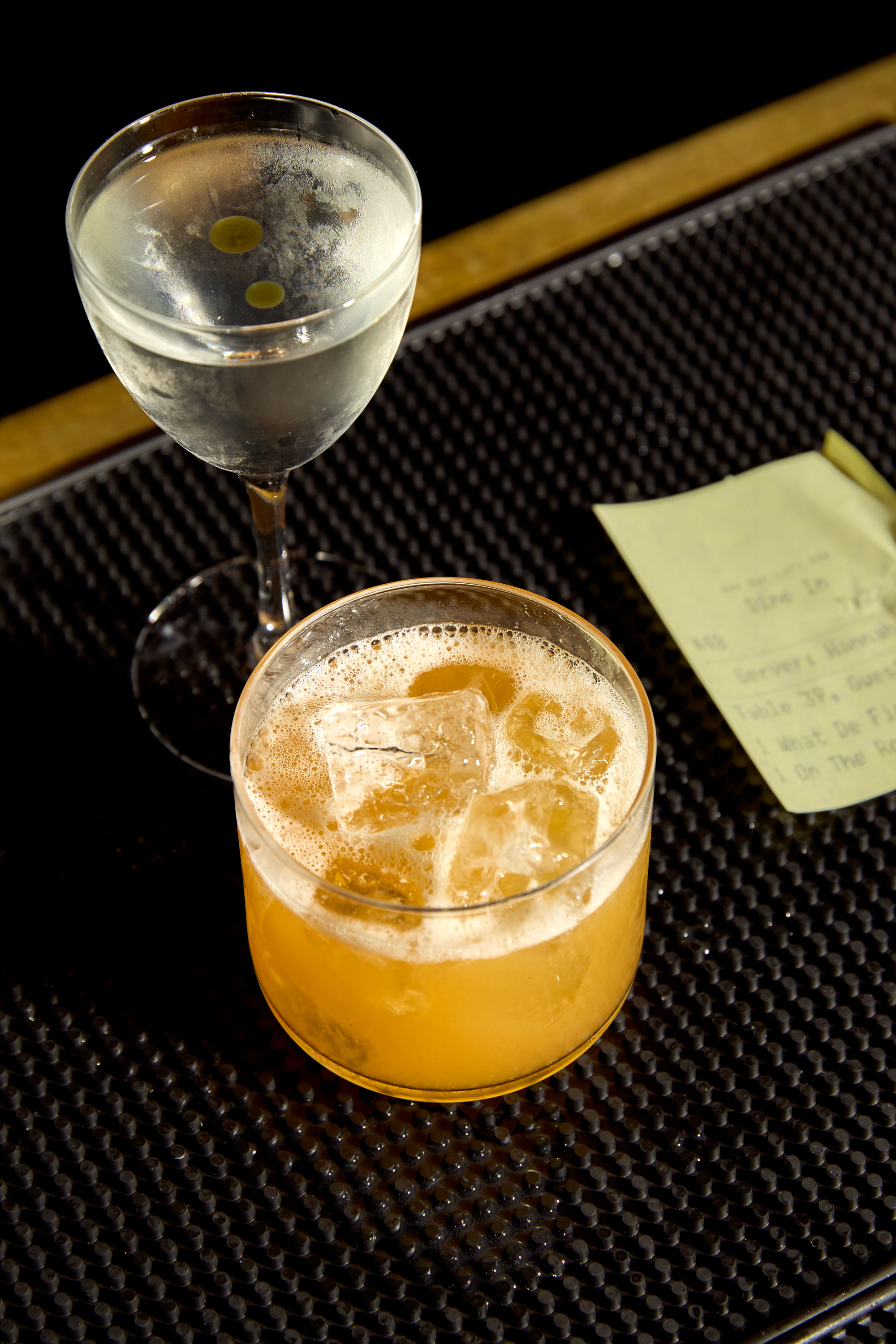 a glass of orange juice next to a cup of coffee