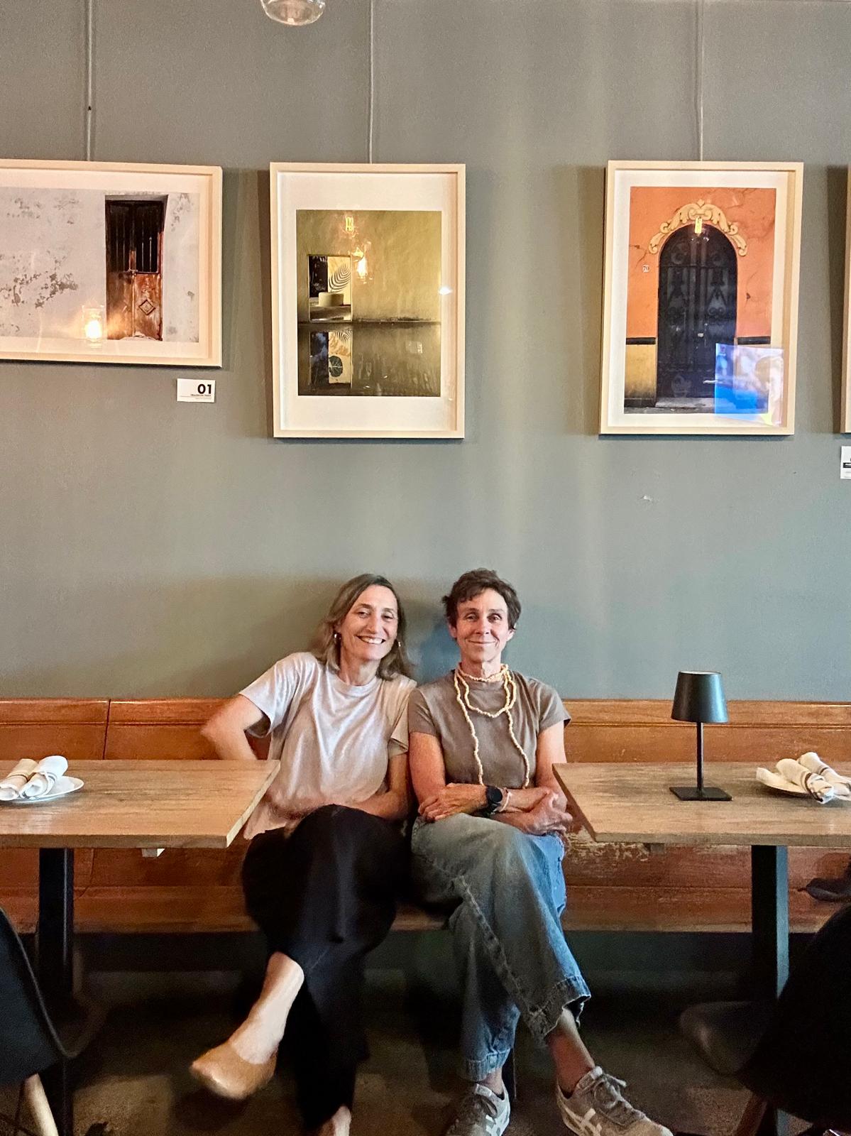 two women sitting on a bench