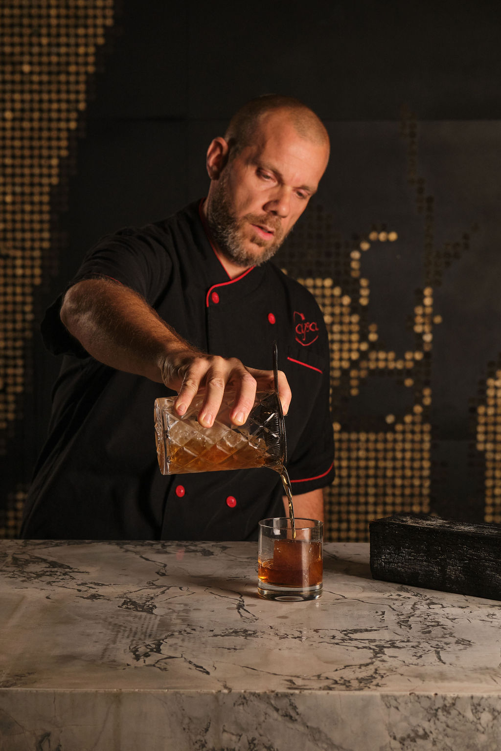 a man standing in front of a cake