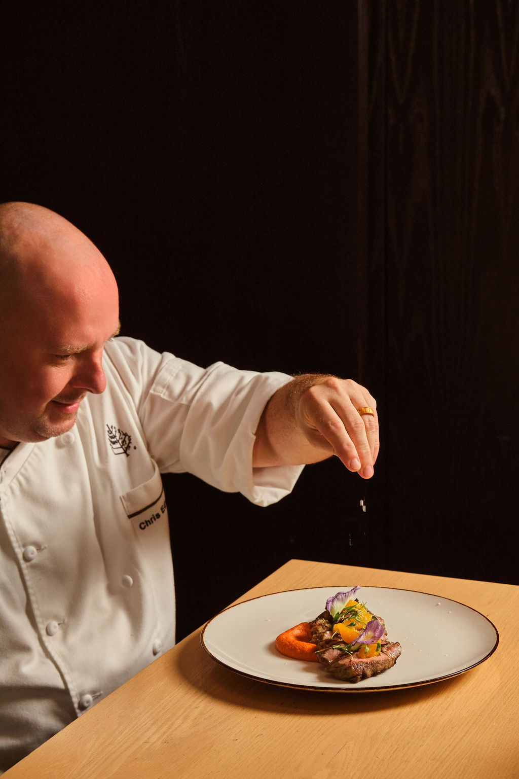 a man putting salt on food