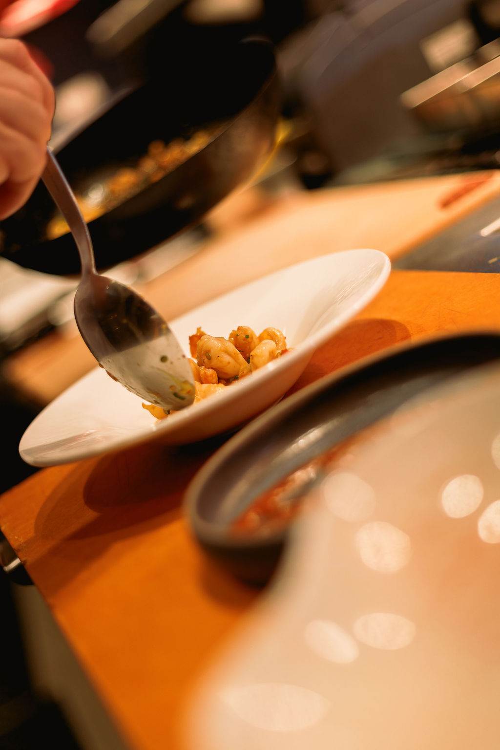 a person holding a spoon over a plate of food