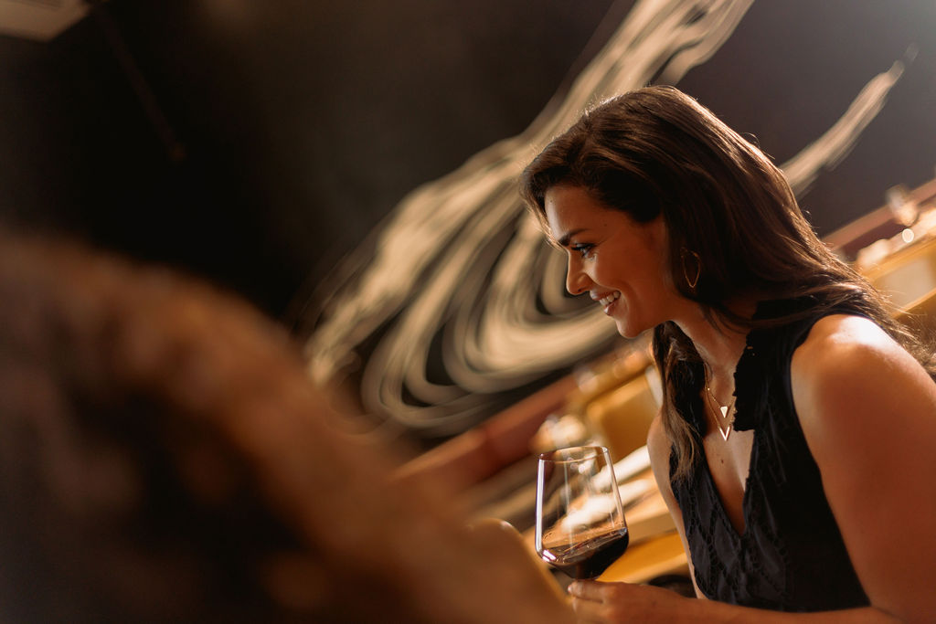 a woman holding a glass of wine
