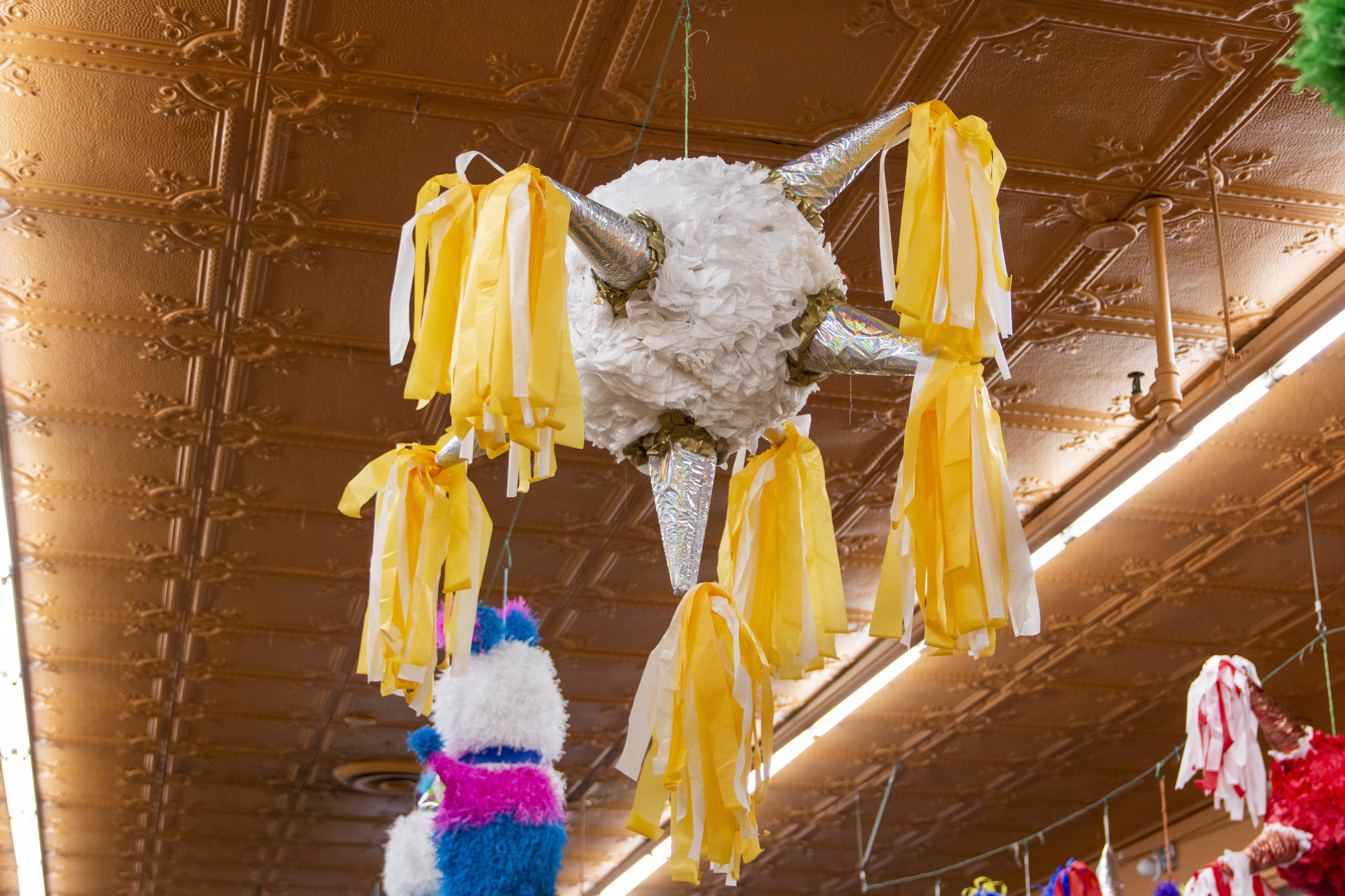 a group of stuffed animals hanging from the ceiling