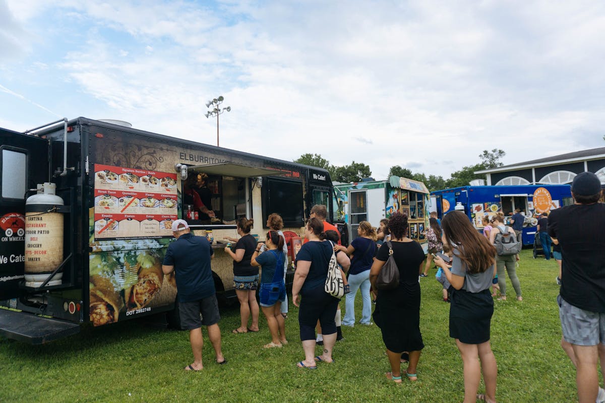 a group of people standing around a bus