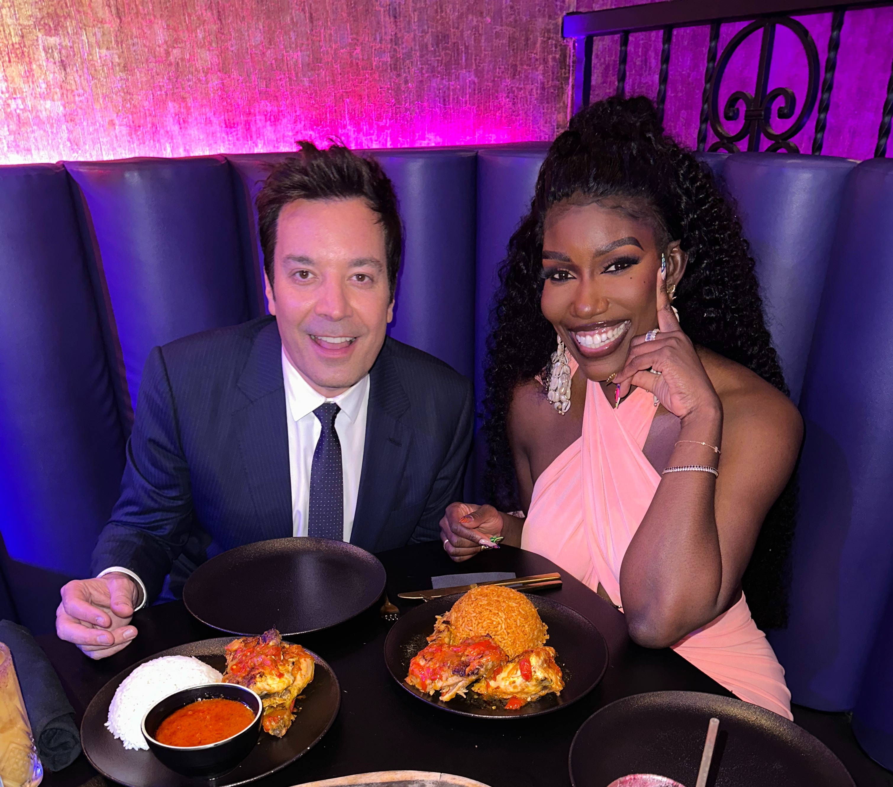 Jimmy Fallon et al. sitting at a table with food