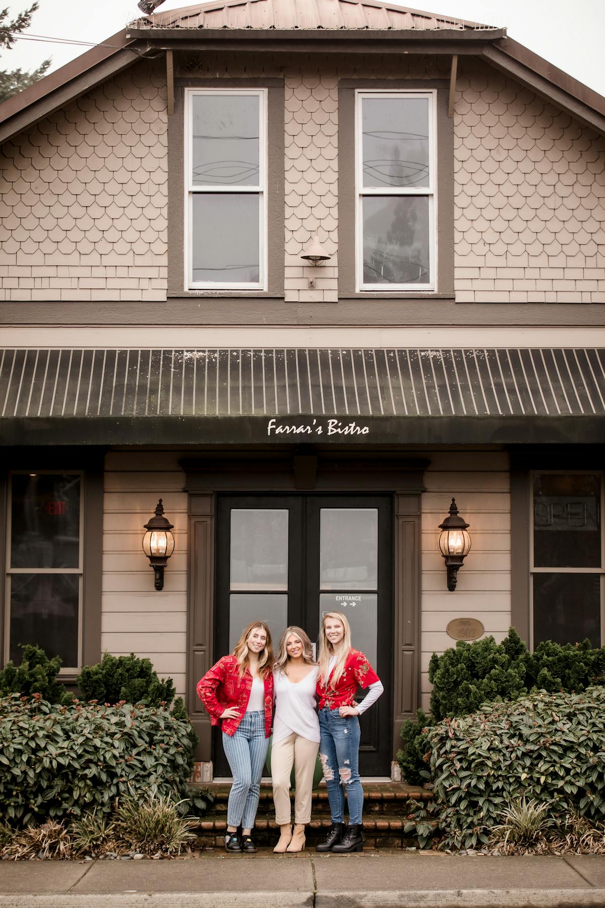 a group of people standing in front of a house