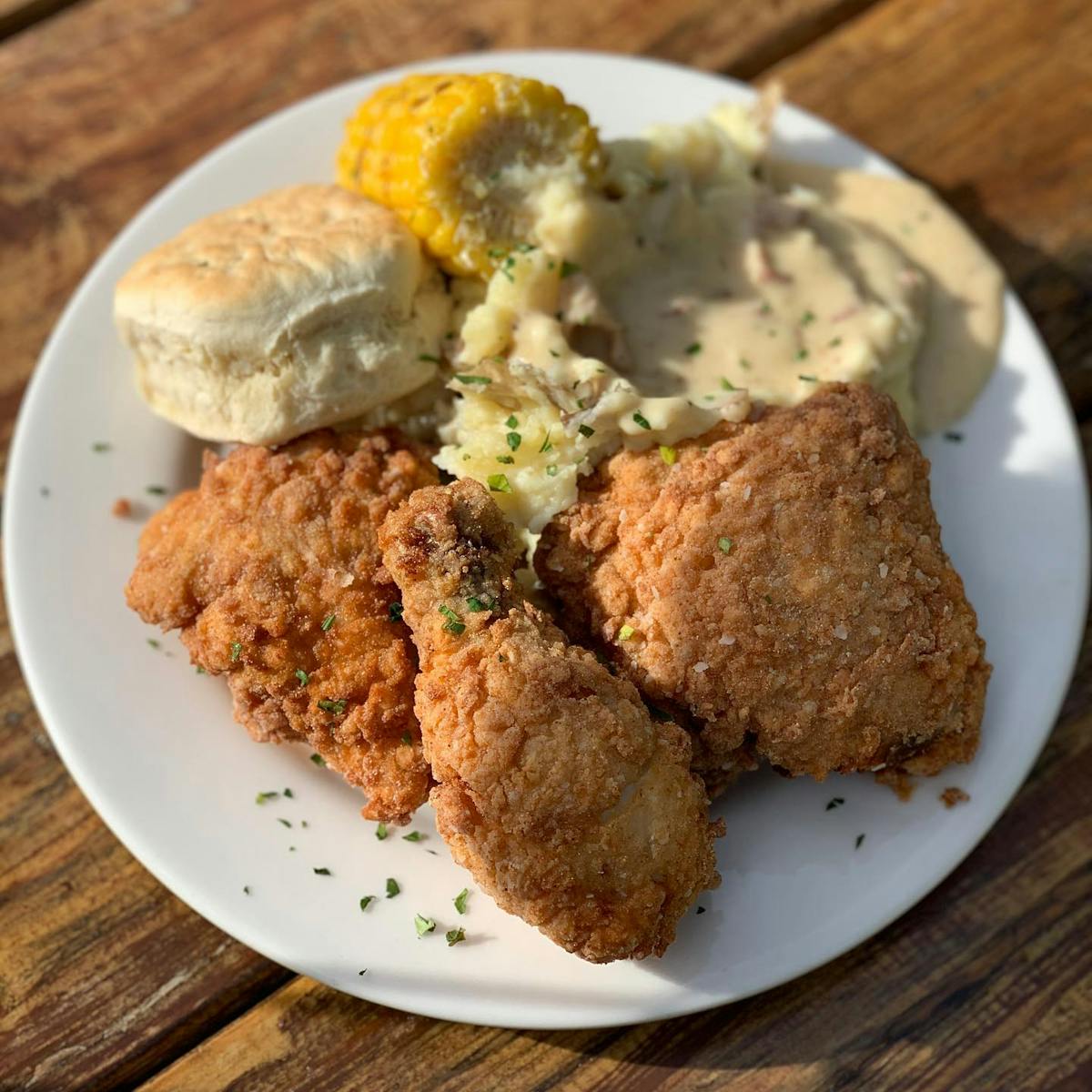 Fried chicken dinner with mashed potatoes, biscuit and corn on the cob
